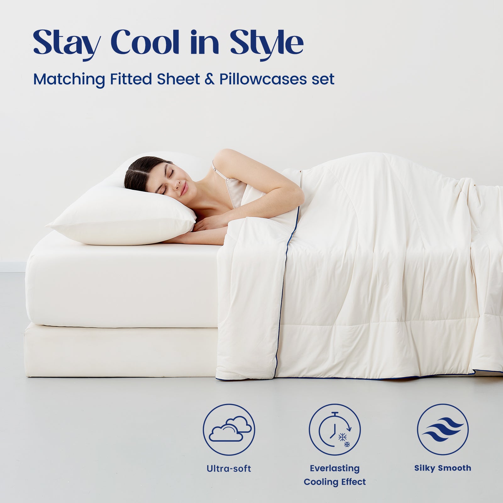Woman lying on a cooling sheet set with matching fitted sheet and pillowcases set.#color_Ivory
