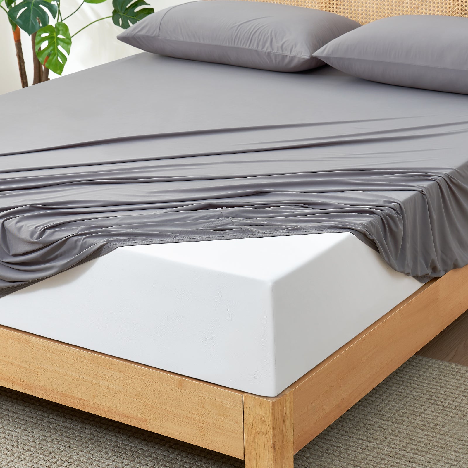 Gray cooling fitted sheet set on bed. Ultra-soft and breathable cozy bedding for comfortable sleep. #Color_Dark Grey