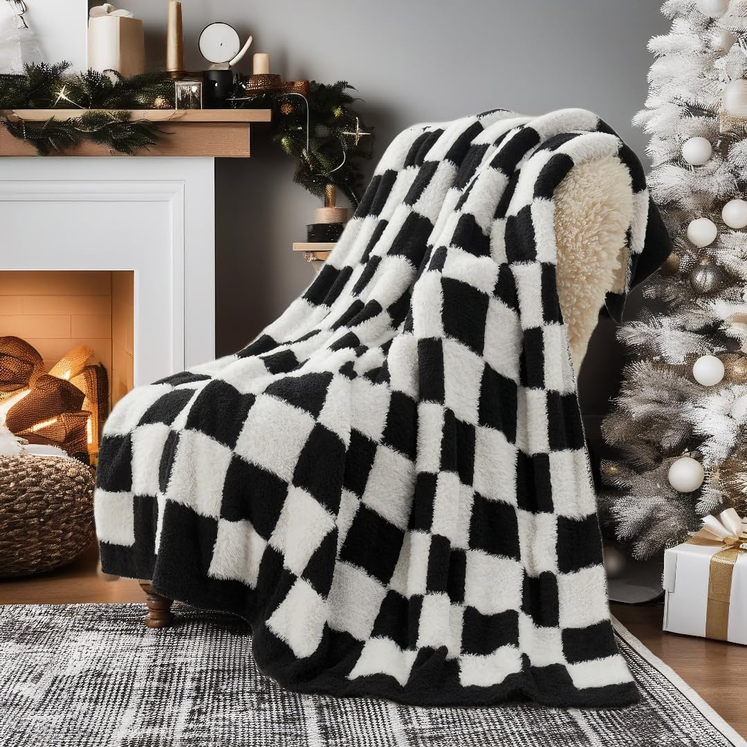 Checkered Faux Fur Feather Yarn Throw Blanket in Black & White draped over a chair, adding a modern stylish touch. #color_Black & White