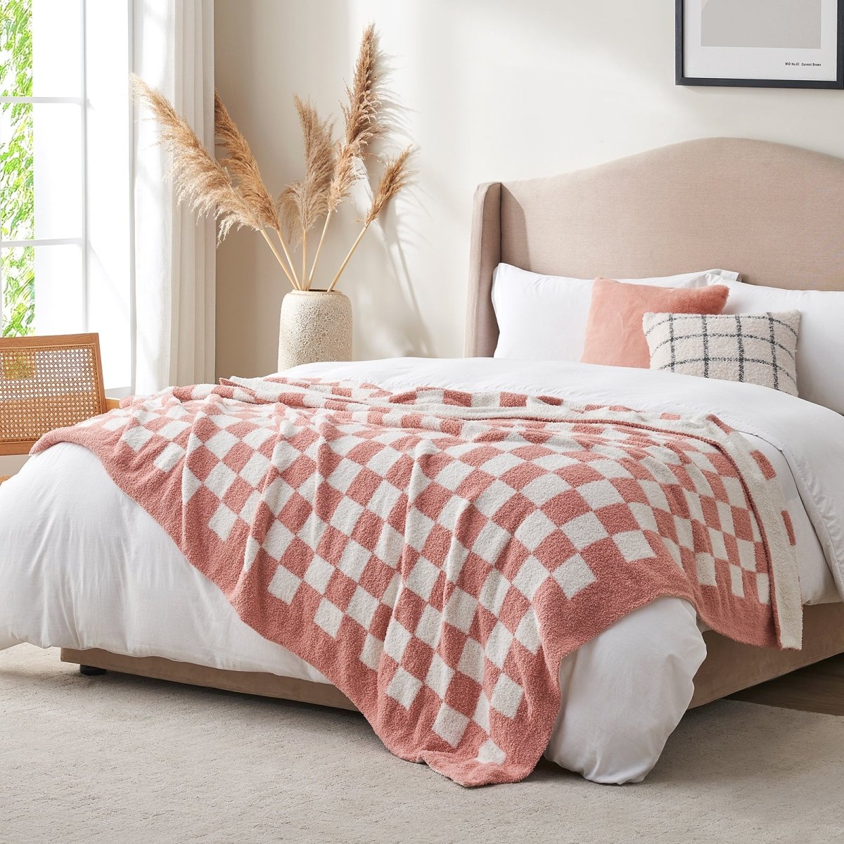 Checkered Feather Yarn Knit Throw Blanket in Pink styled on a bed in a modern bedroom. #color_Pink White
