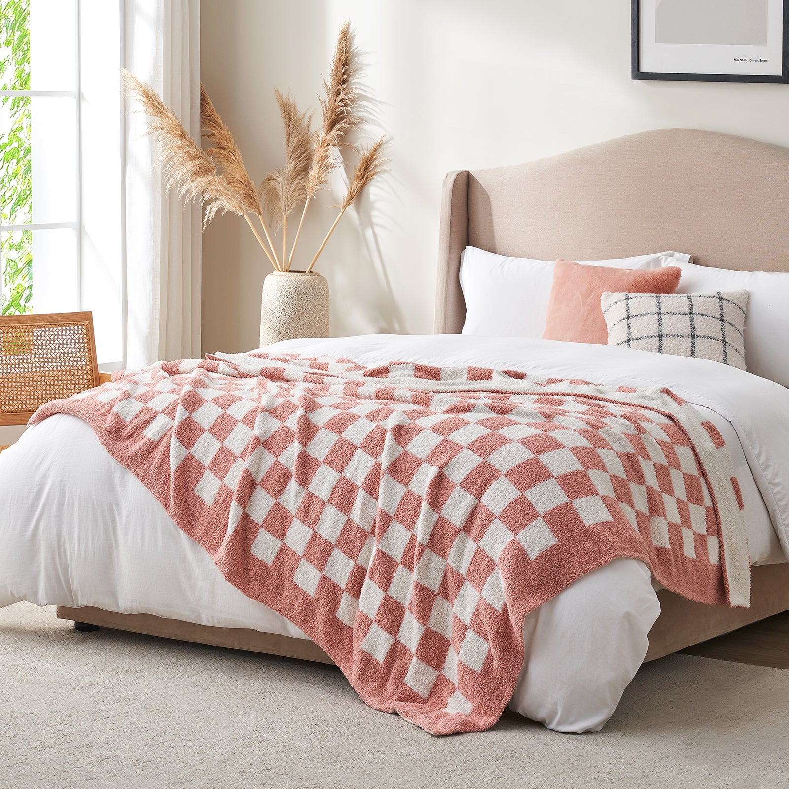 Checkered Feather Yarn Knit Throw Blanket in Pink styled on a bed in a modern bedroom. #color_Pink White