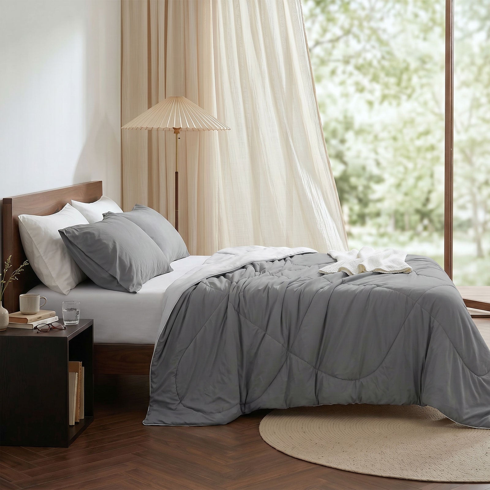Cozy Bliss cooling comforter on bed in side view. Breathable, soft fabric for hot sleepers. #Color_Dark/Light Grey