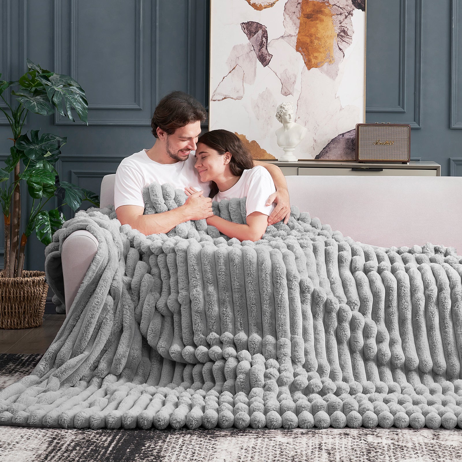 Couple embracing under a Cozy Bliss gray striped faux fur blanket, perfect for a cozy and comfortable experience. #color_Grey