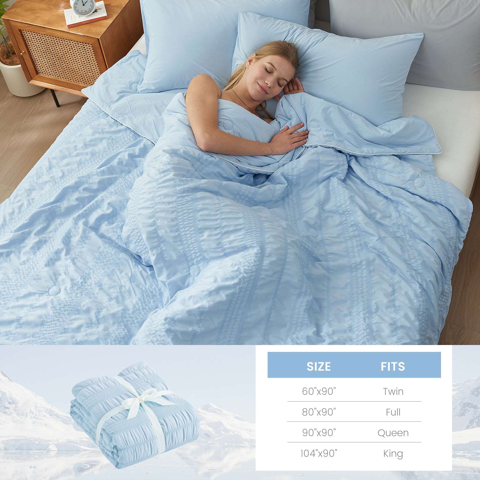 Woman sleeping soundly under Cozy Bliss cooling comforter, size chart #color_Blue