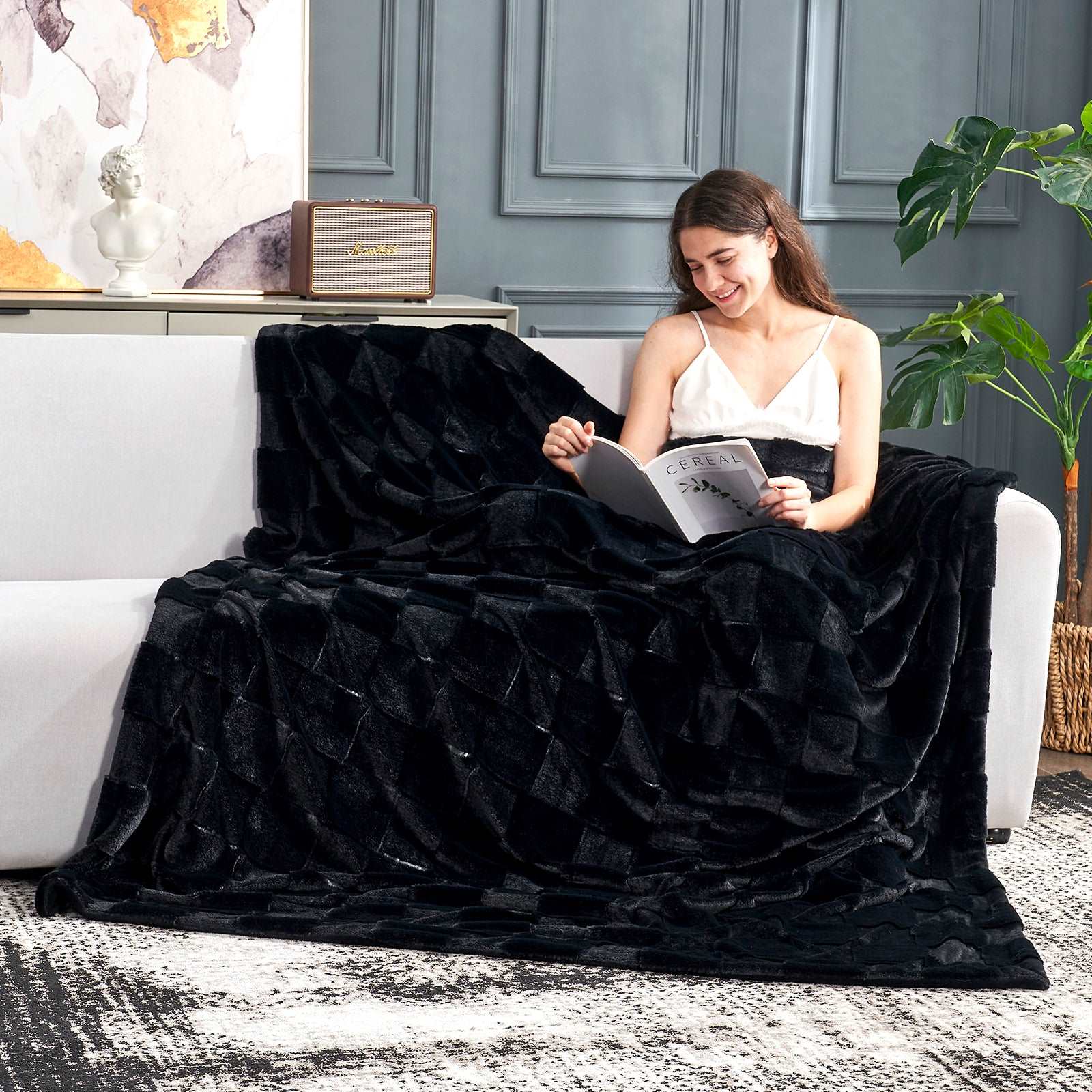 Cozy Bliss Black Faux Fur Blanket, woman relaxing and reading, perfect for cooling and comfort #color_Black