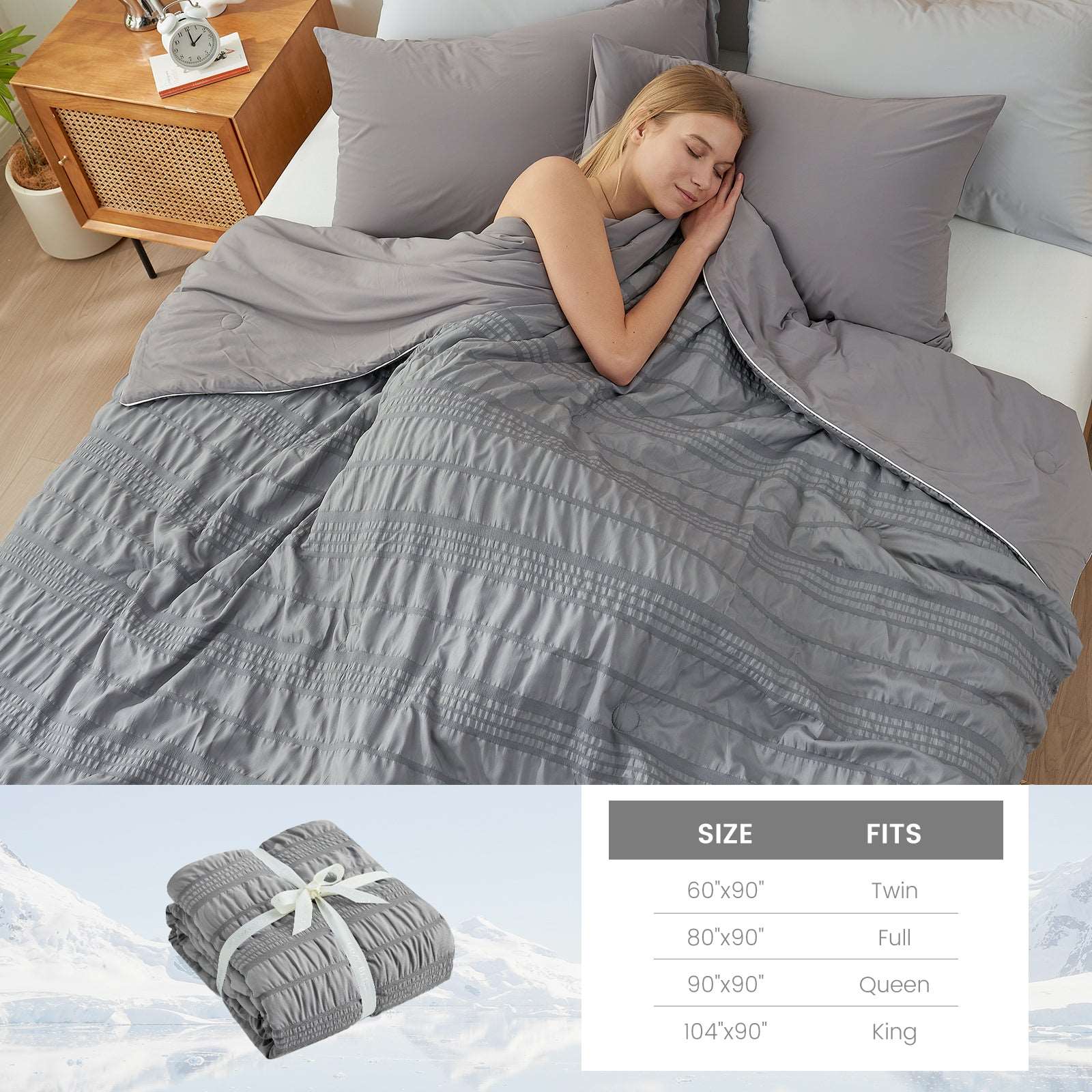 Woman sleeping under gray Cozy Bliss cooling comforter, size chart #color_Dark Grey