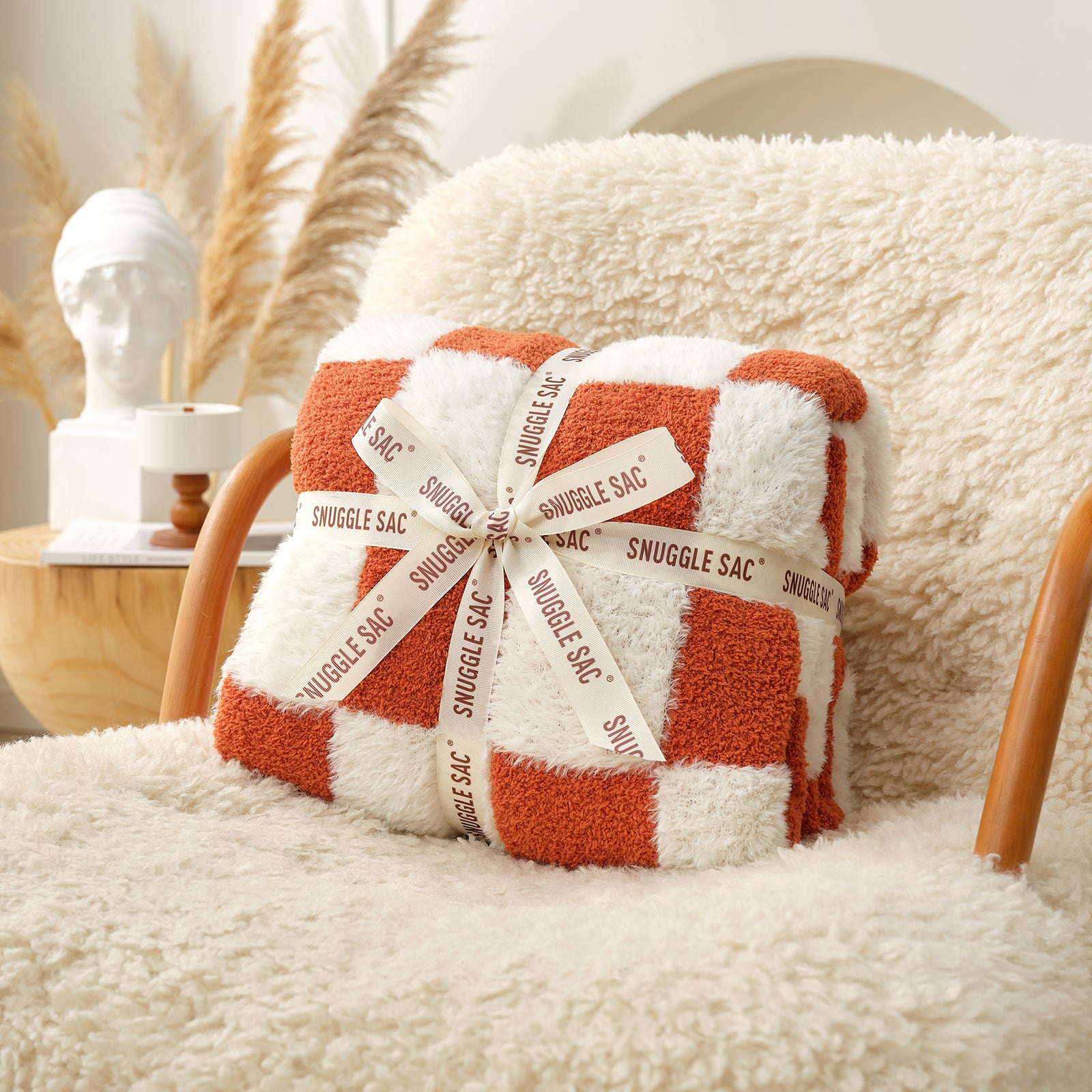 Checkered Faux Fur Feather Yarn Throw Blanket in Orange neatly folded with ribbon, ideal for gifting. #color_Orange