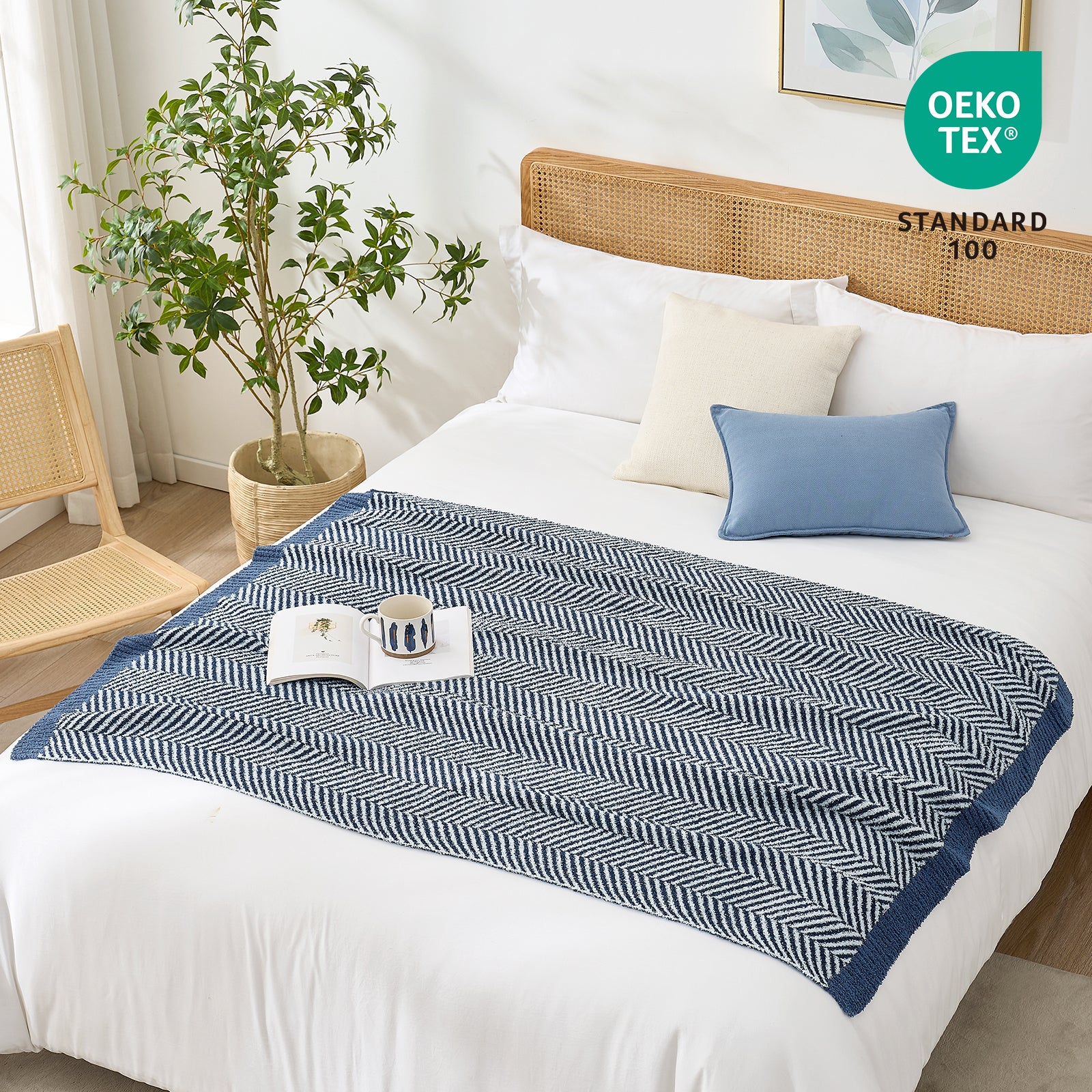 OEKO-TEX STANDARD 100 certified herringbone knit throw blanket styled on a white bed #color_Navy Blue