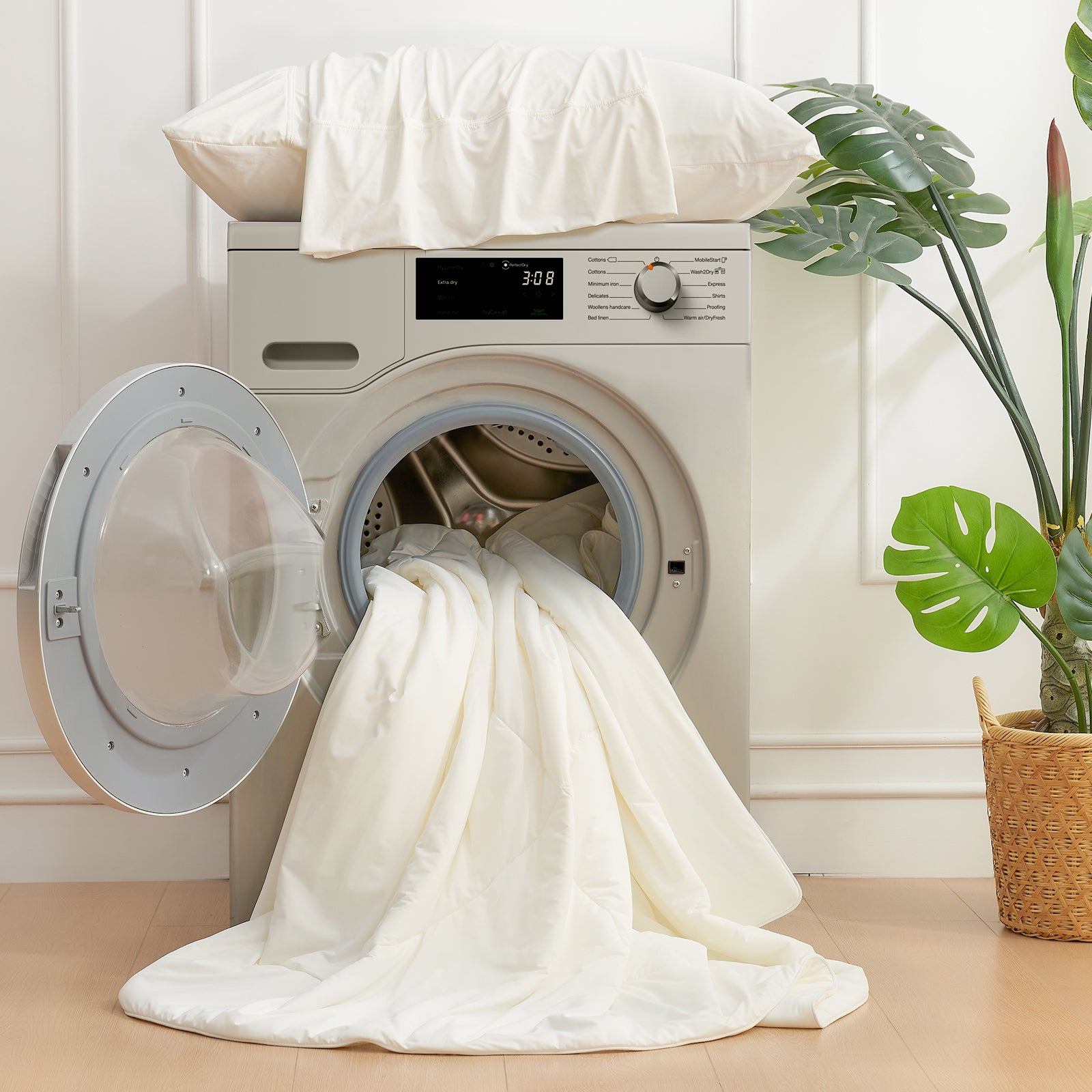 White cooling comforter in washing machine, easy care. Ideal for breathable and soft summer sleep. #Color_White