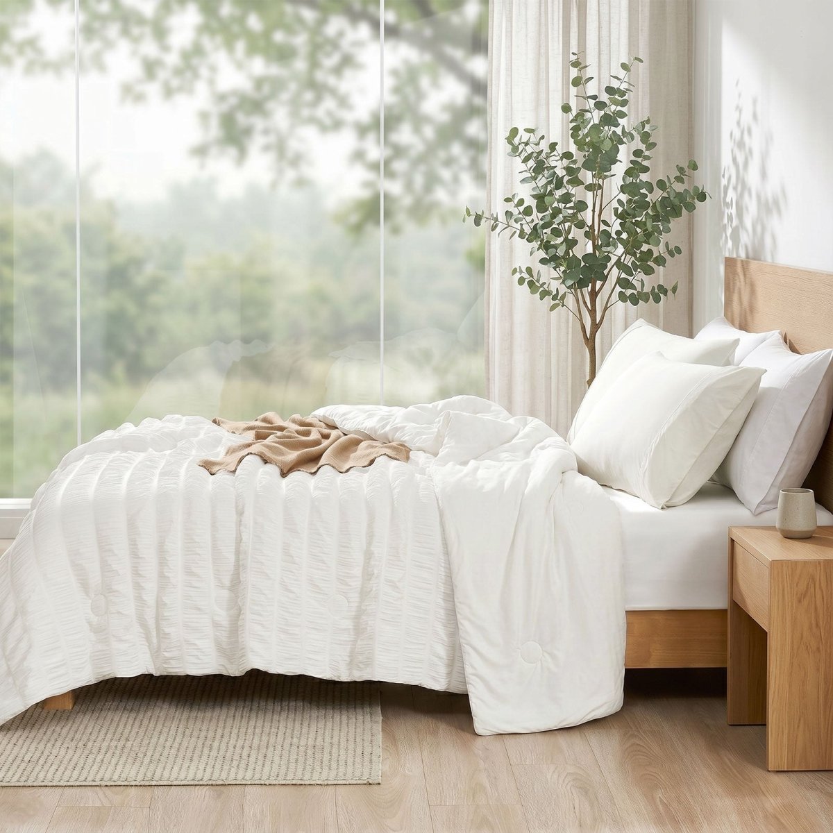 Cozy Bliss vertical striped seersucker cooling comforter in side view.#color_Off White