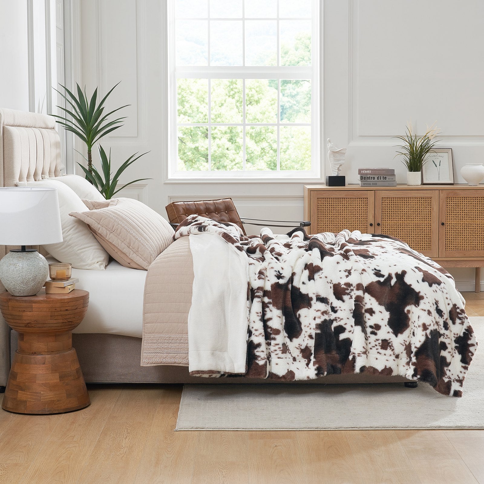 Cow print faux fur blanket on bed. Soft, stylish cow pattern for a luxurious bedroom decor. #cozy bedding #color_Black/Coffee