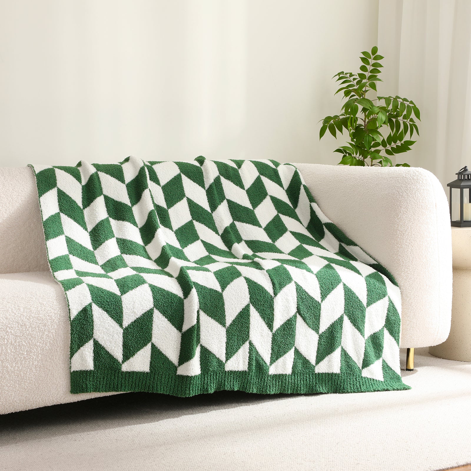 Chevron Feather Yarn Knit Throw Blanket in Xmas Green draped over a sofa, creating a warm atmosphere. #color_Xmas Green