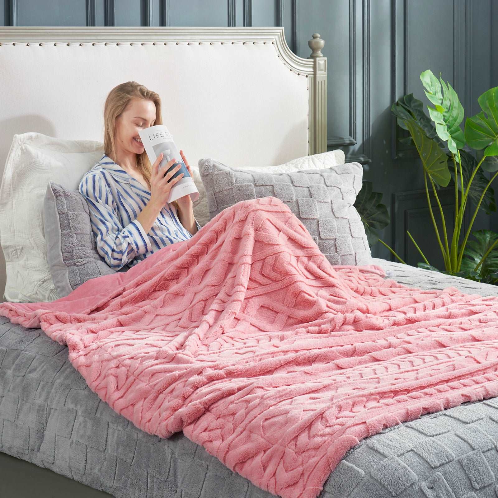 Pink cable knit faux fur throw blanket on a bed, woman reading a book, cozy bedding, soft blanket. #color_Hot Pink