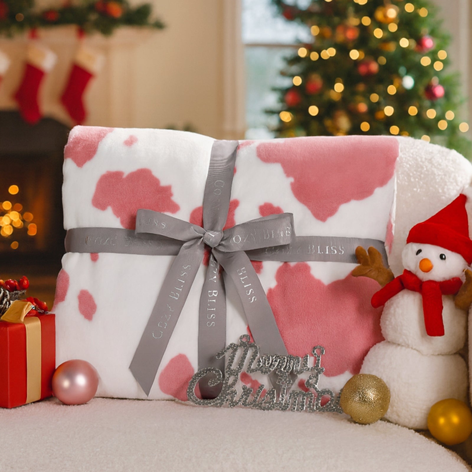 Gift wrapped in pink and white pattern with a gray ribbon, surrounded by Christmas decorations. #color_Strawberry