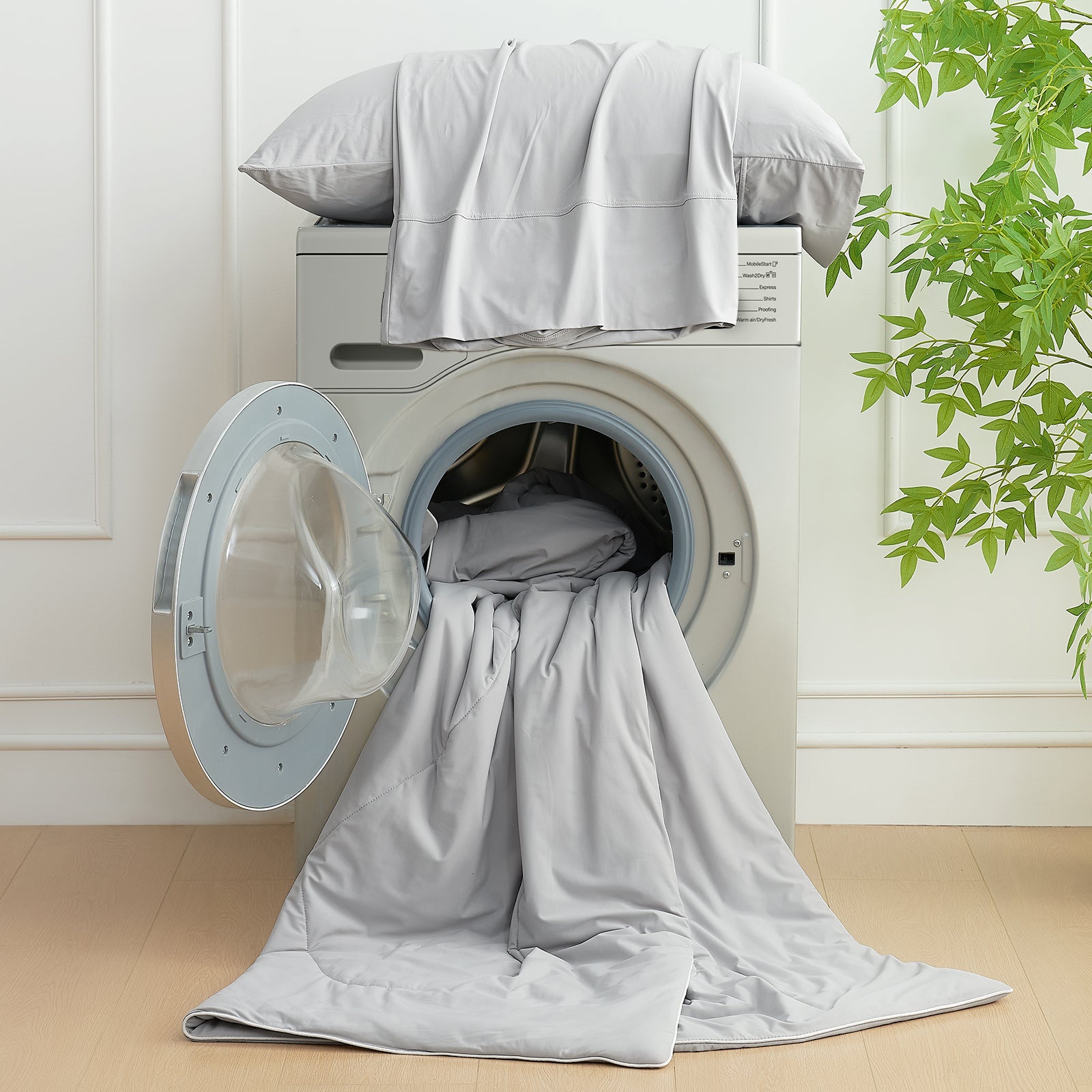 Cozy Bliss cooling comforter, easy to wash, soft and breathable, displayed in a washing machine. #Color_Grey