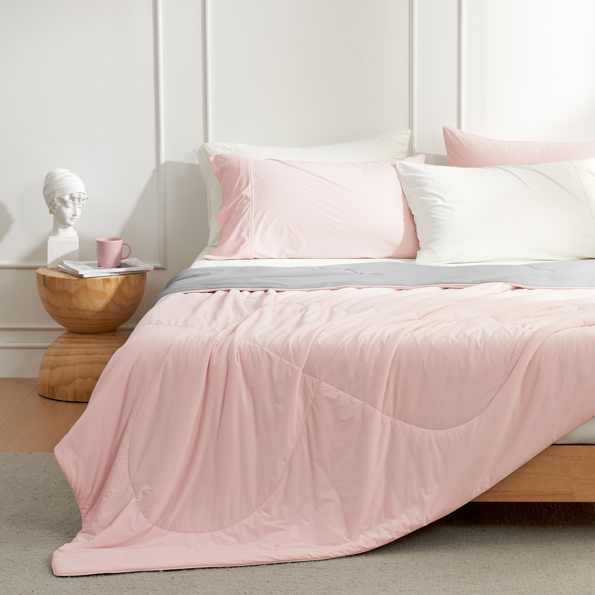 Cozy Bliss pink cooling comforter on bed, breathable bedding for hot sleepers, with pillows #Color_Pink/Grey