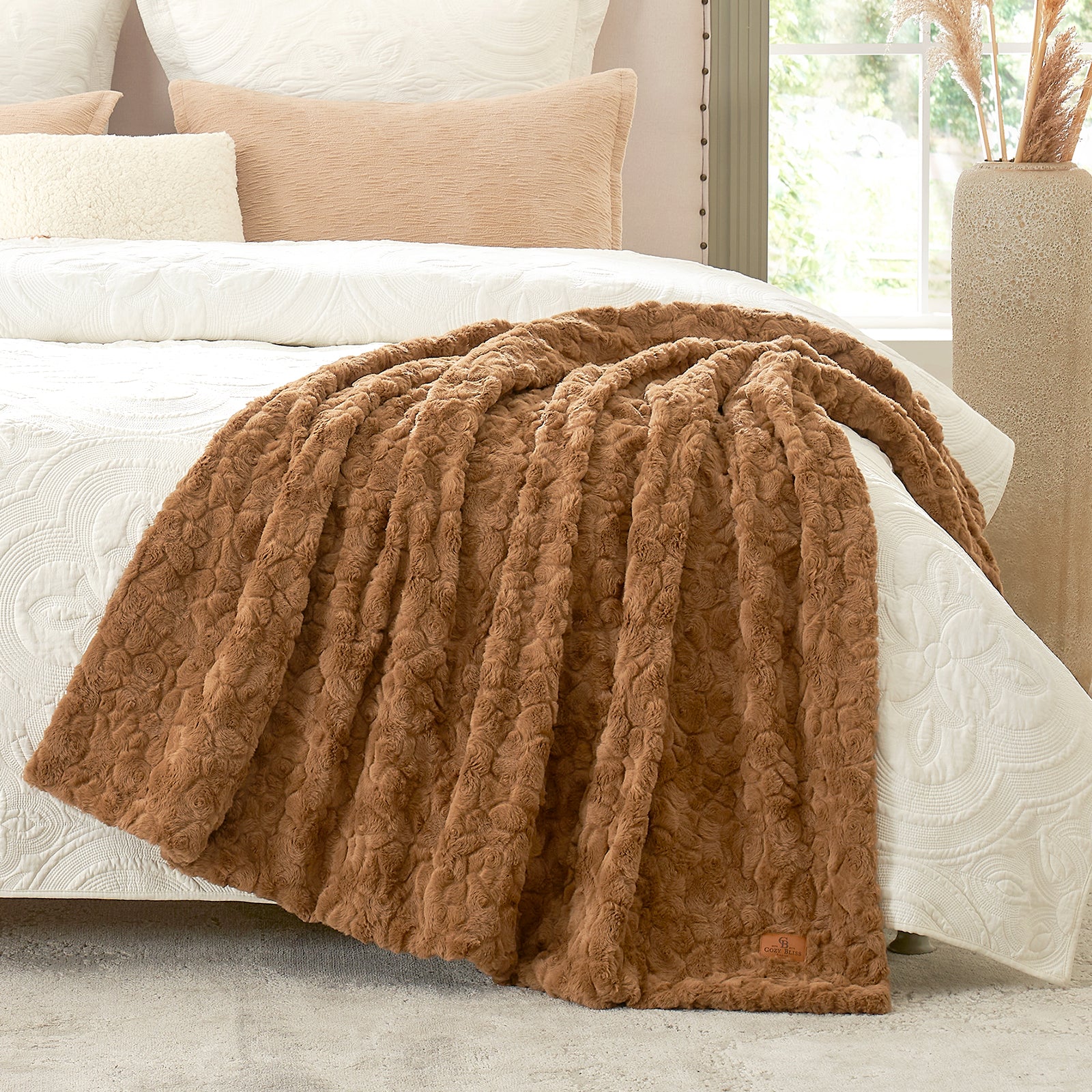 Brown textured blanket on a bed with white bedding and beige pillows. #color_Brown