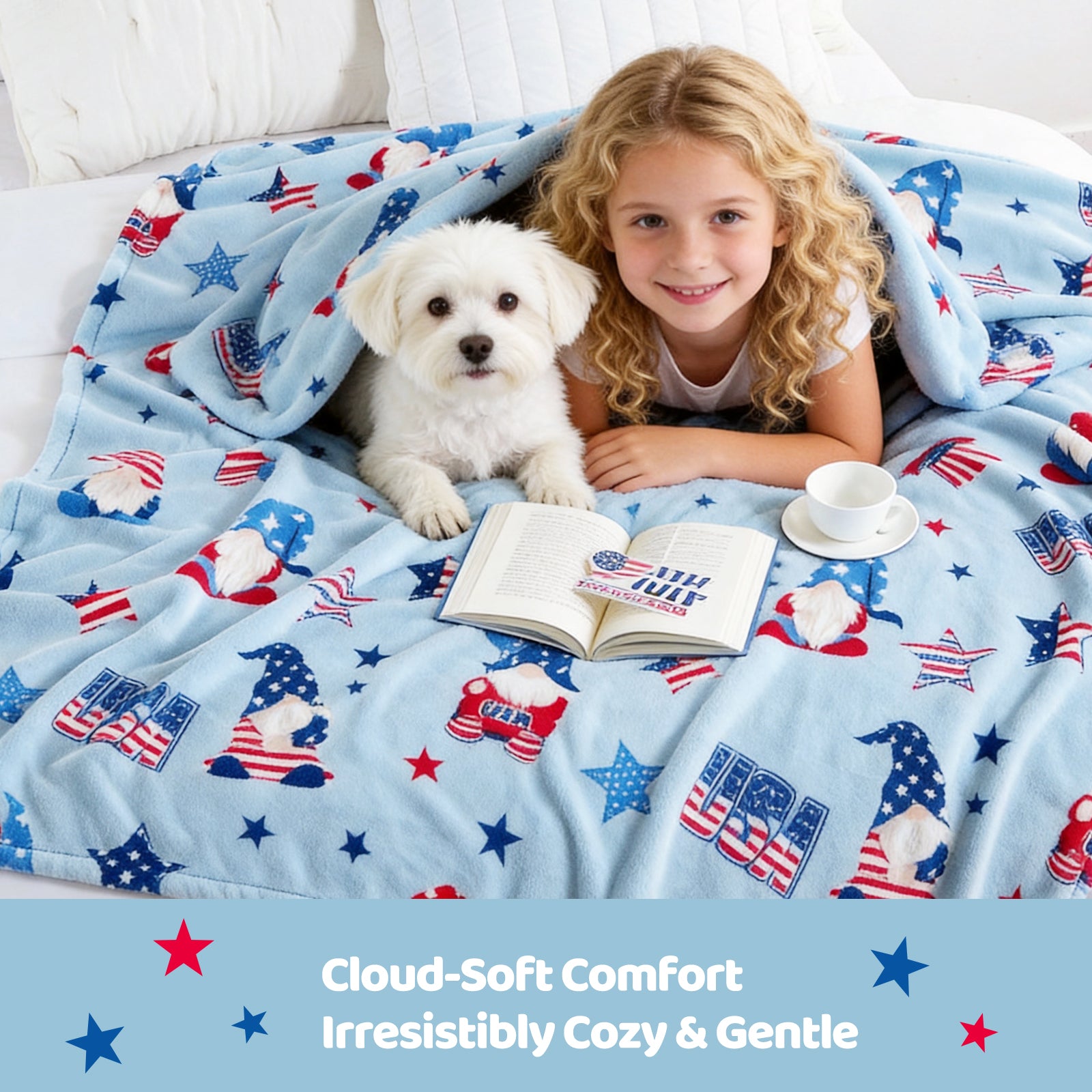 Child and dog under a patriotic-themed blanket with a book and cup on a bed.#color_Blue