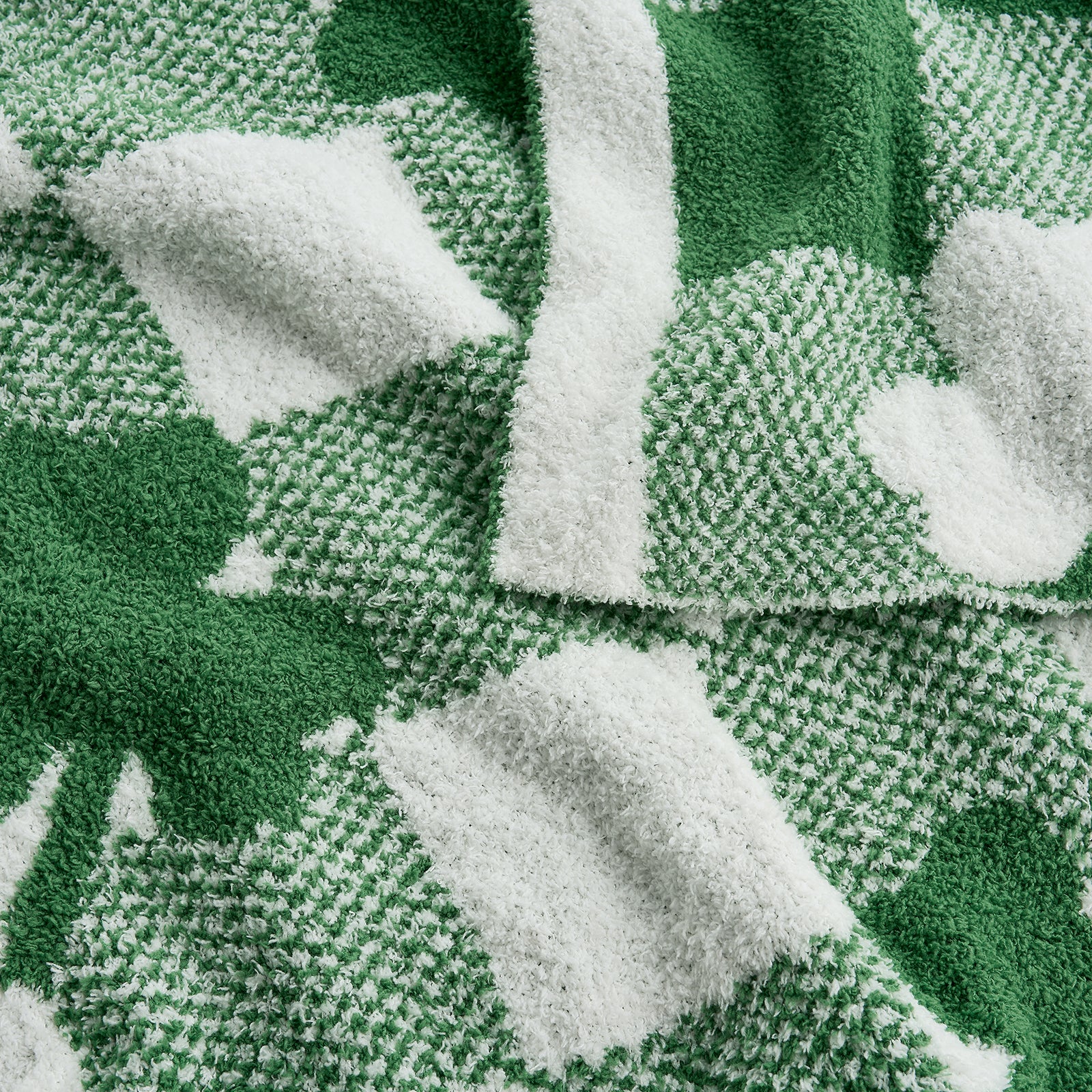 Close-up of a green and white patterned fabric with leaf designs. #color_Xmas Green