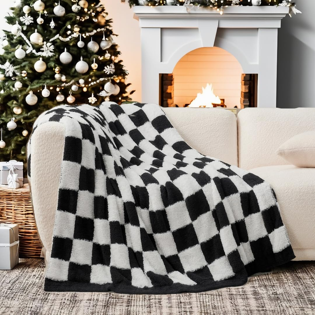Checkered Faux Fur Feather Yarn Throw Blanket in Black & White draped over a sofa, highlighting its bold design. #color_Black & White
