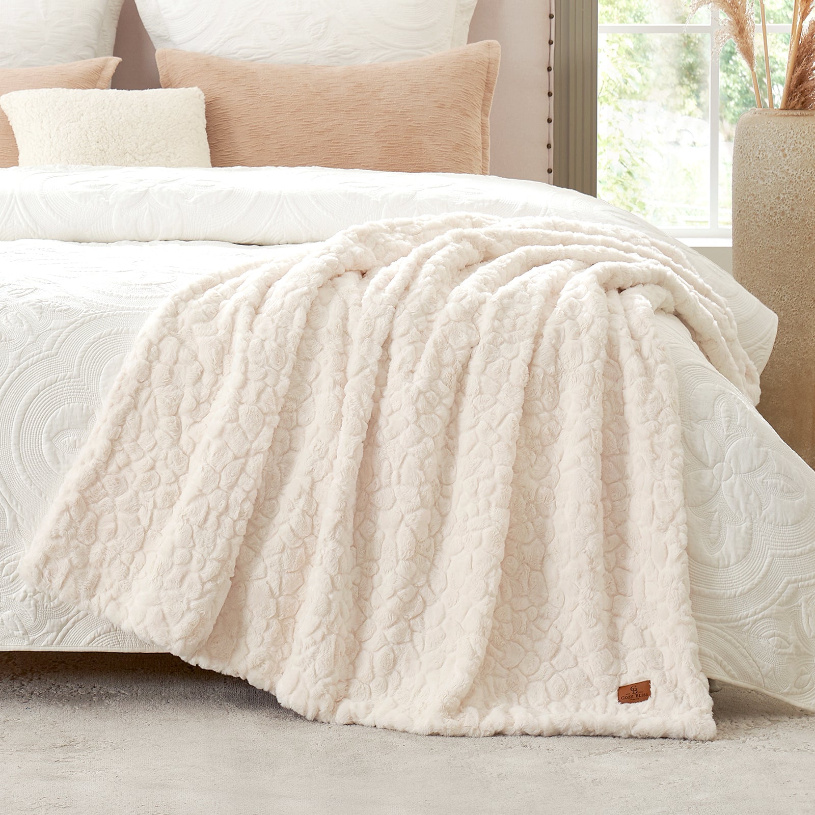 White textured blanket on a bed with pillows in a bedroom setting #color_Cream White