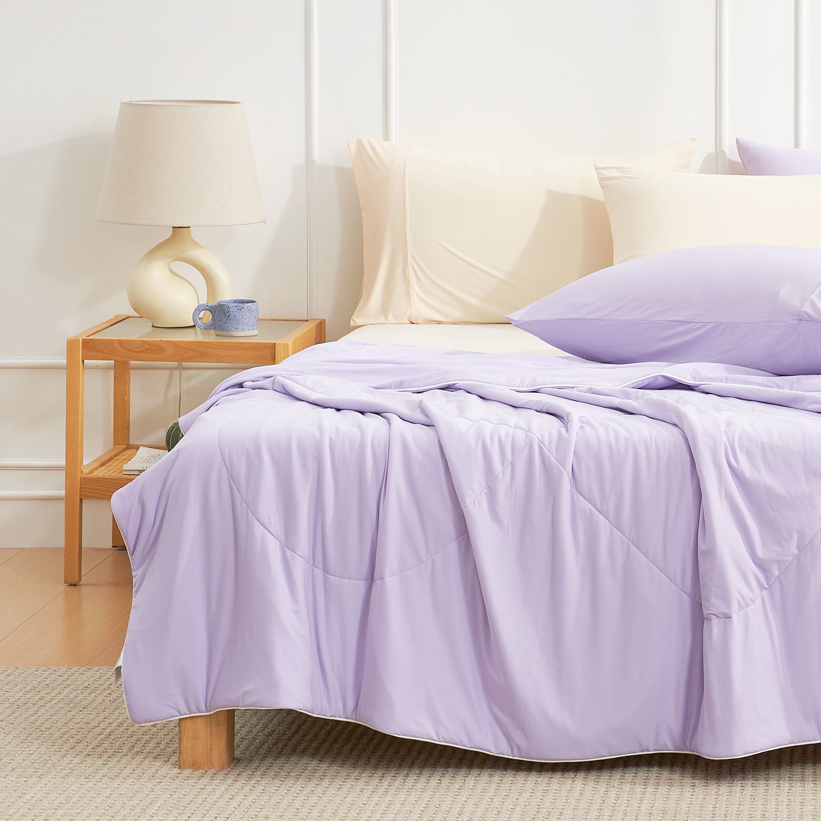 Cozy Bliss light purple cooling comforter on bed with pillows, breathable bedding for hot sleepers. #Color_Purple