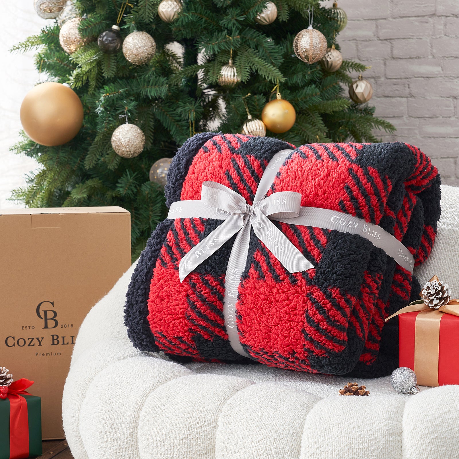Red and black plaid blanket with a white ribbon in front of a decorated Christmas tree. #Color_Red/Black Buffalo Check