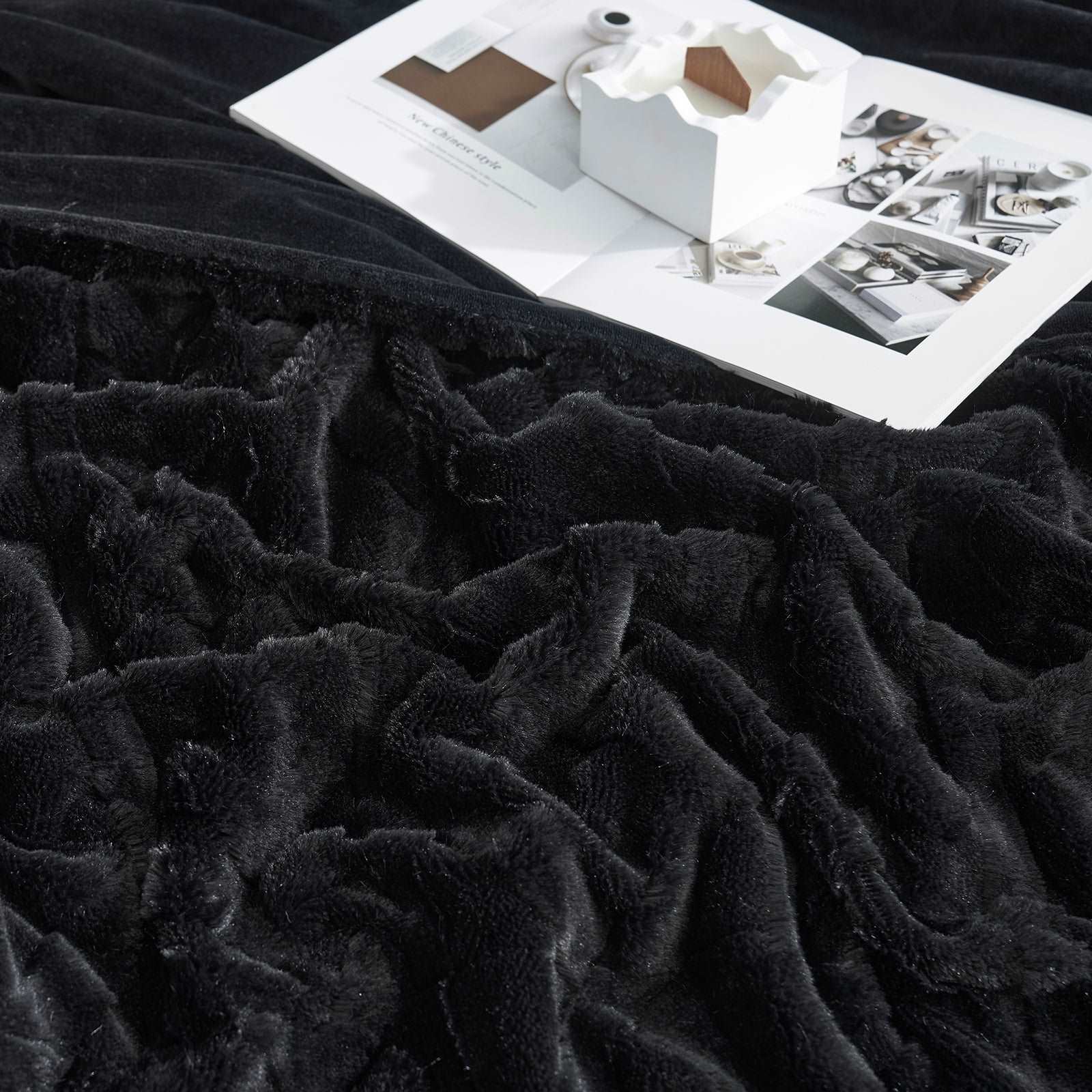 Black Cozy Bliss faux fur blanket, a soft and cozy home decor essential. "New Chinese Style" book shown. #color_Black
