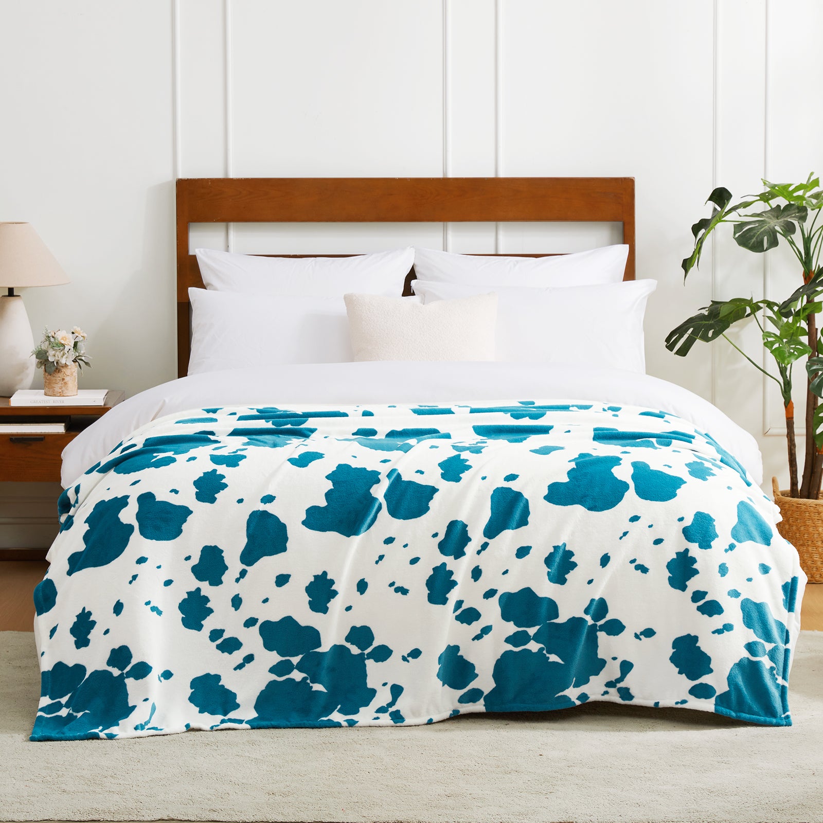 Bed with blue and white patterned comforter in a bedroom setting #color_Blue