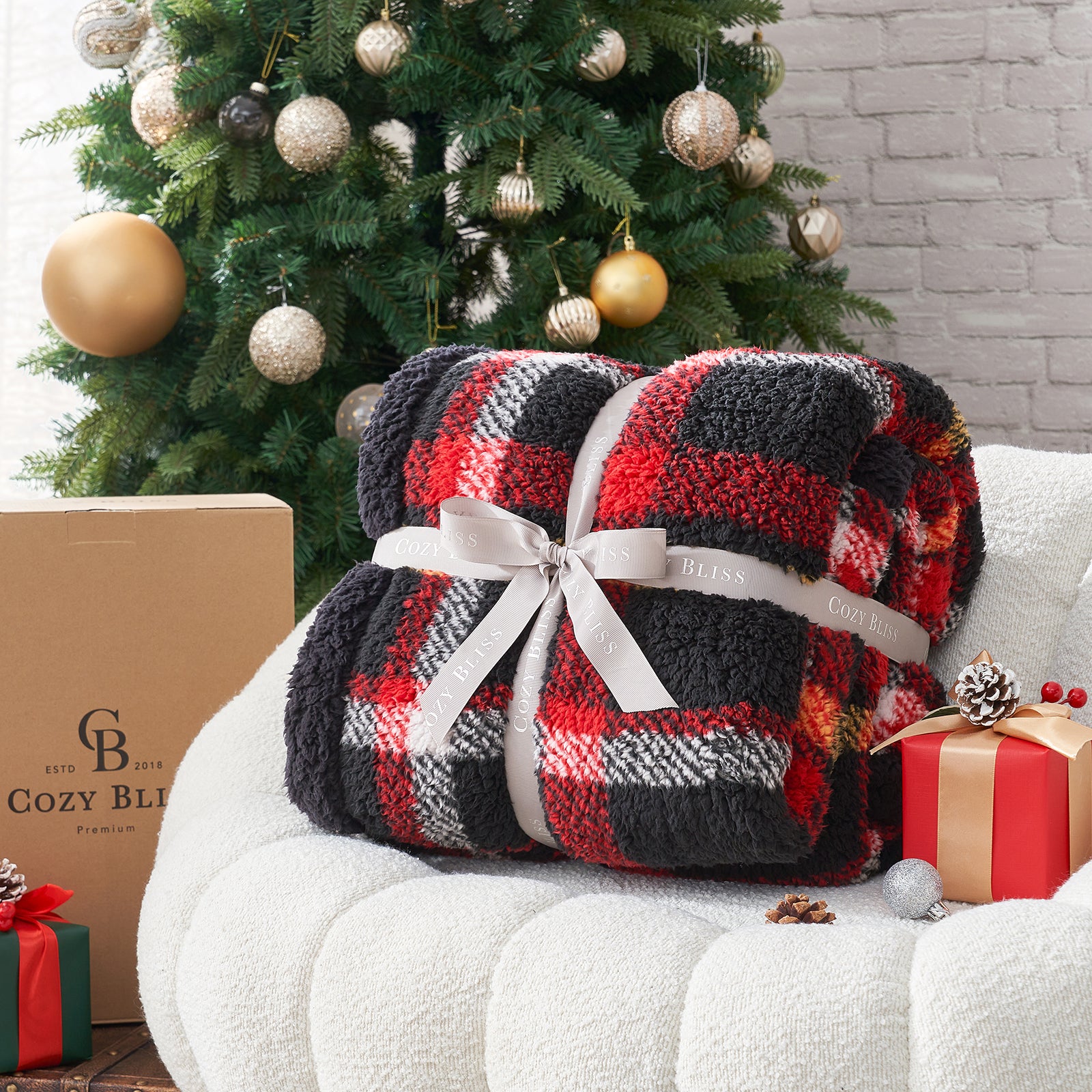 Plaid blanket with a ribbon in front of a decorated Christmas tree and presents. #Color_Scotland Plaid Red