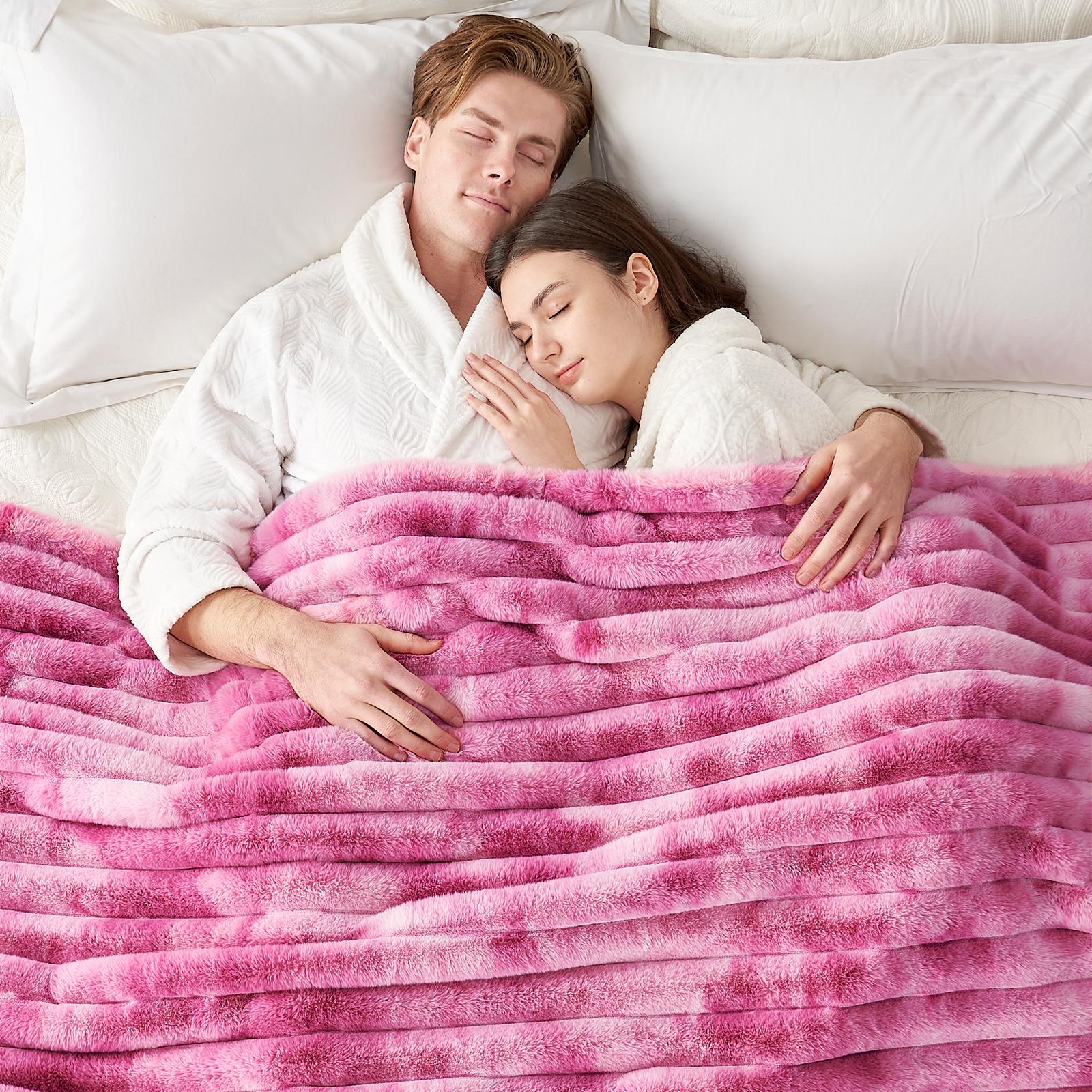 Couple sleeping under a pink striped faux fur blanket, Cozy Bliss cozy bedding. #color_Tie-dye Pink