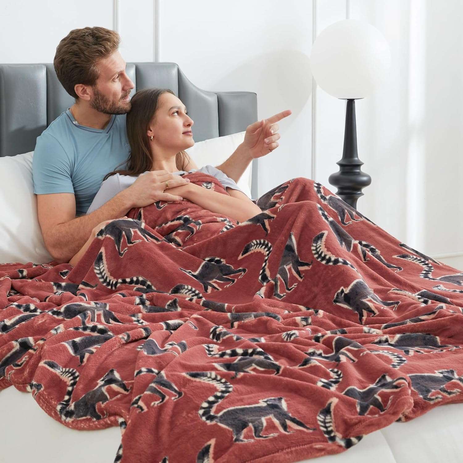 Couple cuddling under Lemur print fleece blanket, cozy bedding #color_Proud Lemur