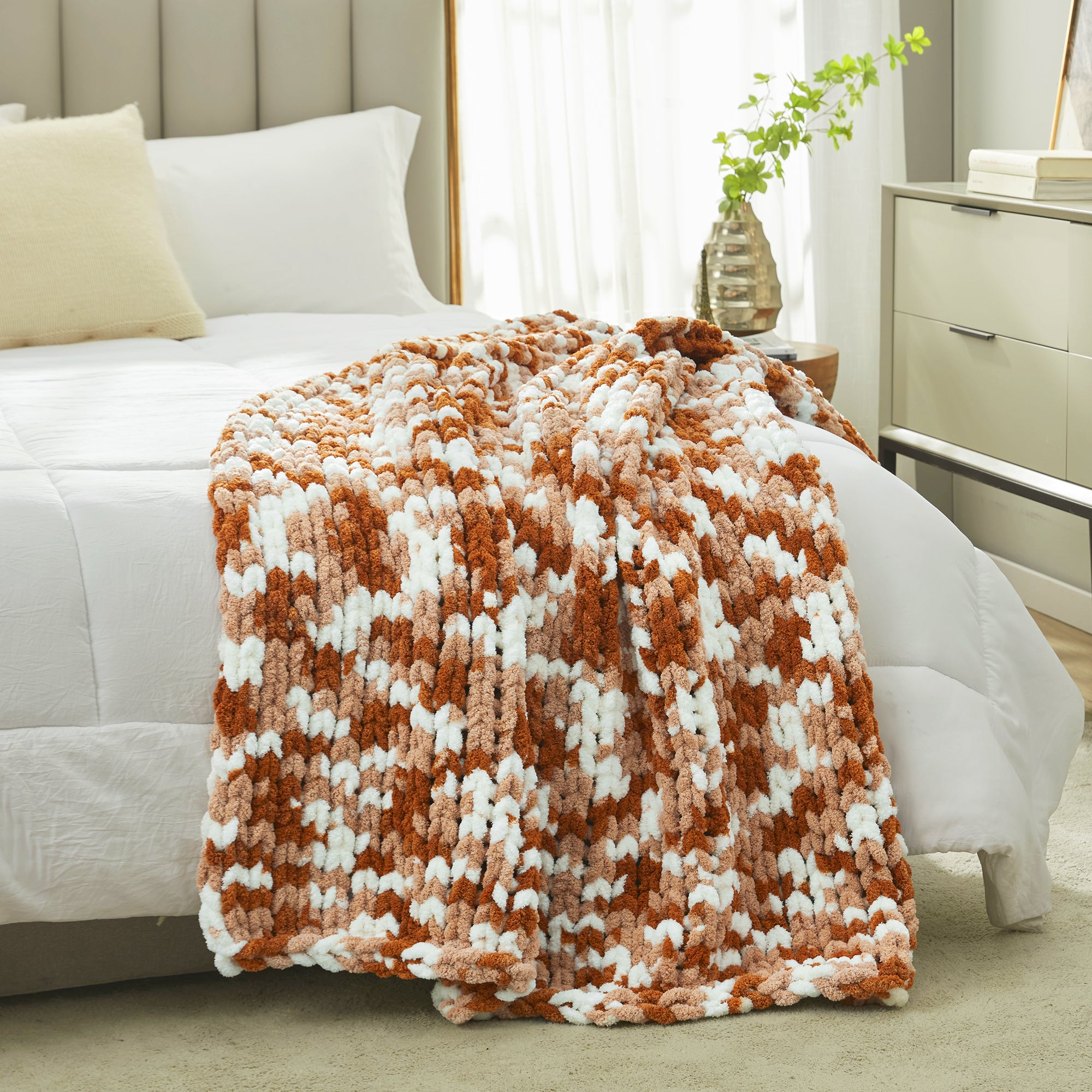 Fluffy brown and white blanket on a bed in a bedroom setting #Color_Burnt Orange
