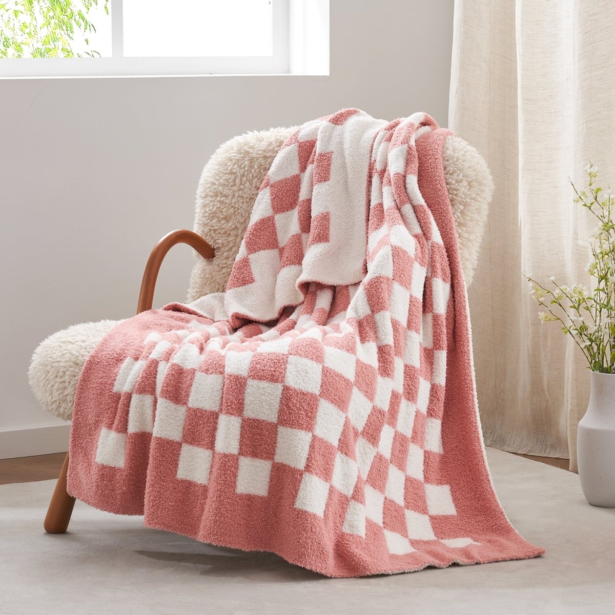 Checkered Feather Yarn Knit Throw Blanket in Pink White front view draped over a chair, showcasing soft texture and checkered pattern design. #color_Pink White