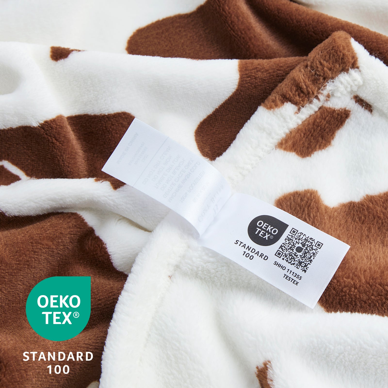 Close-up of a brown and white patterned fabric with an Oeko-Tex label. #color_Brown