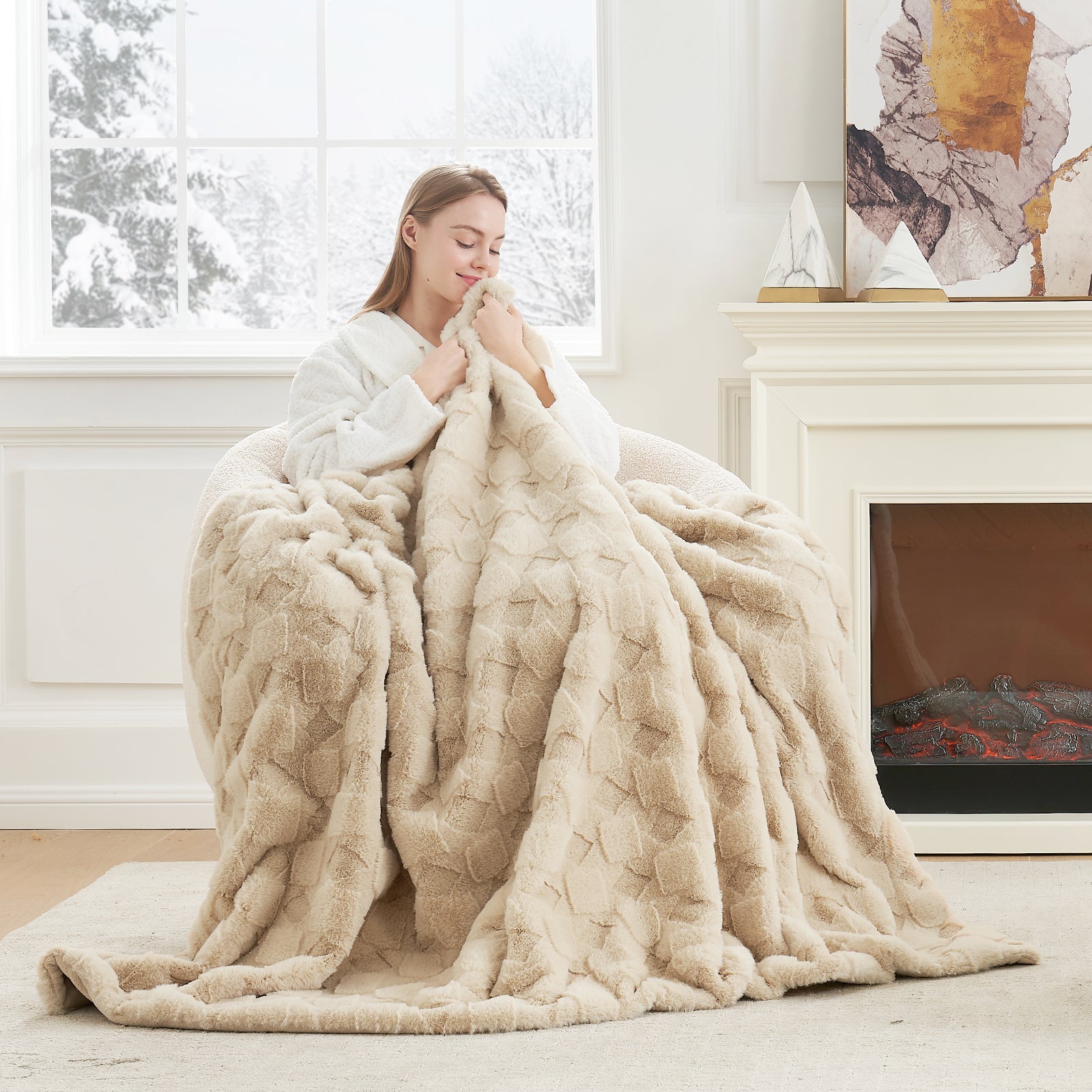 Woman wrapped in a large beige blanket in a cozy living room. #color_Beige