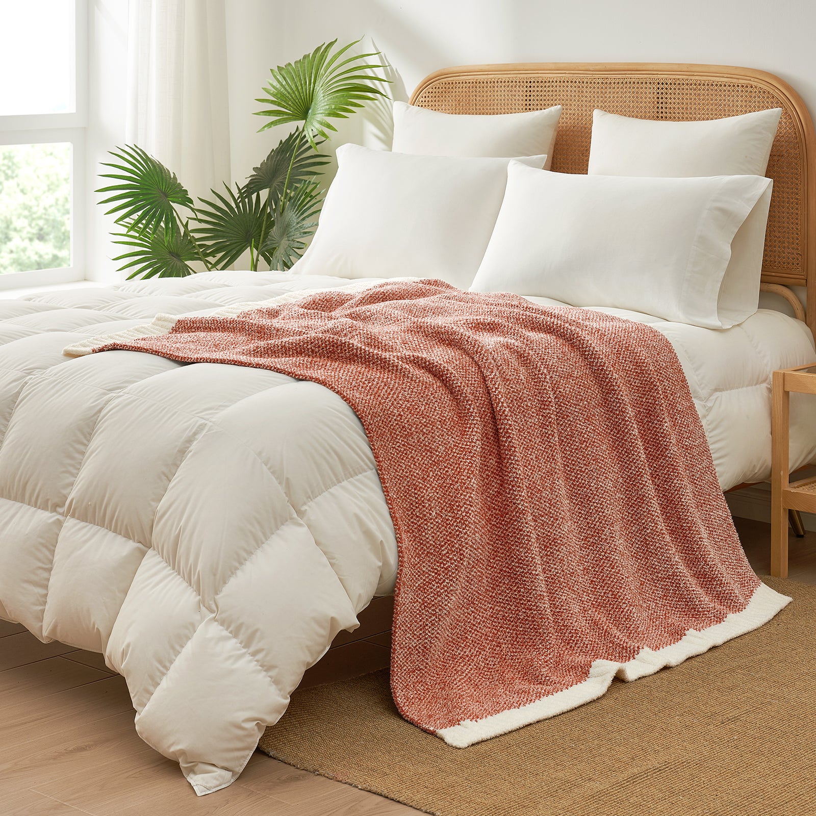 Heather Feather Yarn Throw Blanket in orange styled on a bed, enhancing bedroom decor with a soft, elegant and cozy layered look. #Color_Orange
