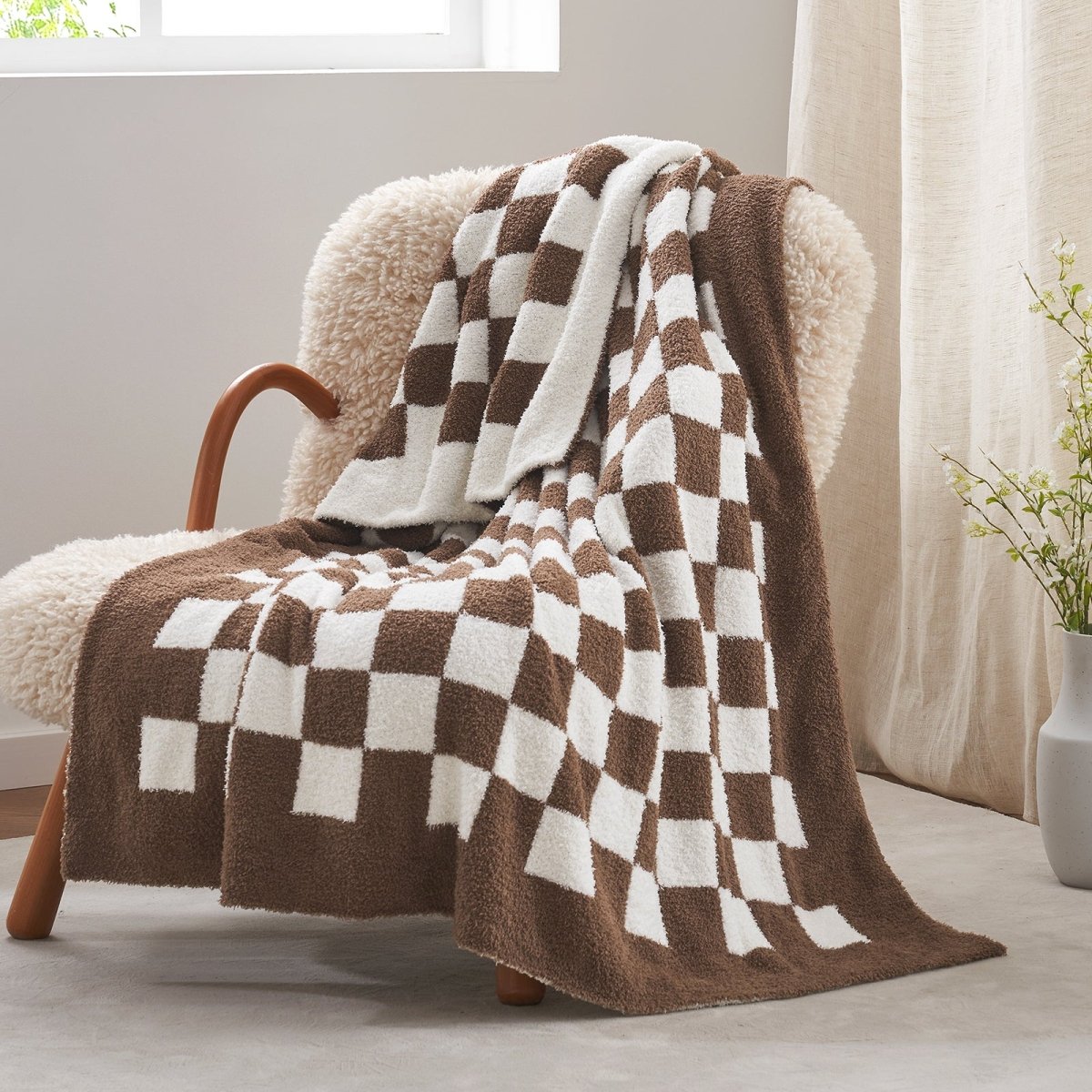 Checkered Feather Yarn Knit Throw Blanket in Brown front view draped over a chair, showcasing soft texture and warm checkered design. #color_Brown