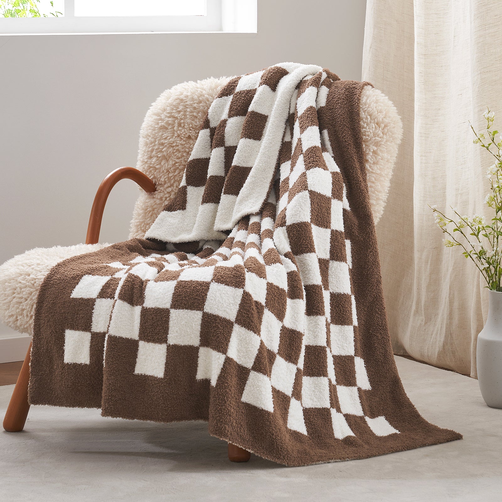 Checkered Feather Yarn Knit Throw Blanket in Brown front view draped over a chair, showcasing soft texture and warm checkered design. #color_Brown