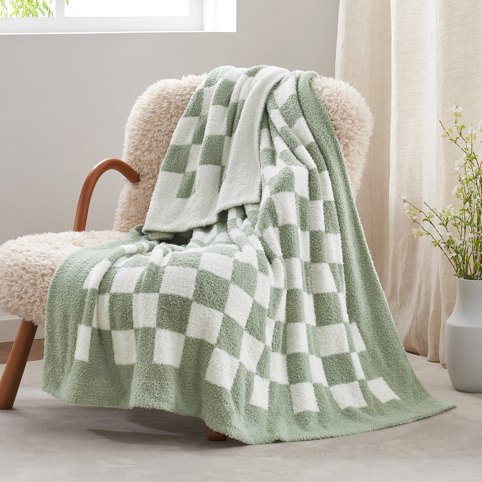 Checkered Feather Yarn Knit Throw Blanket in Sage Green & White front view draped over a chair, showcasing soft texture and checkered pattern design. #color_Sage Green & White