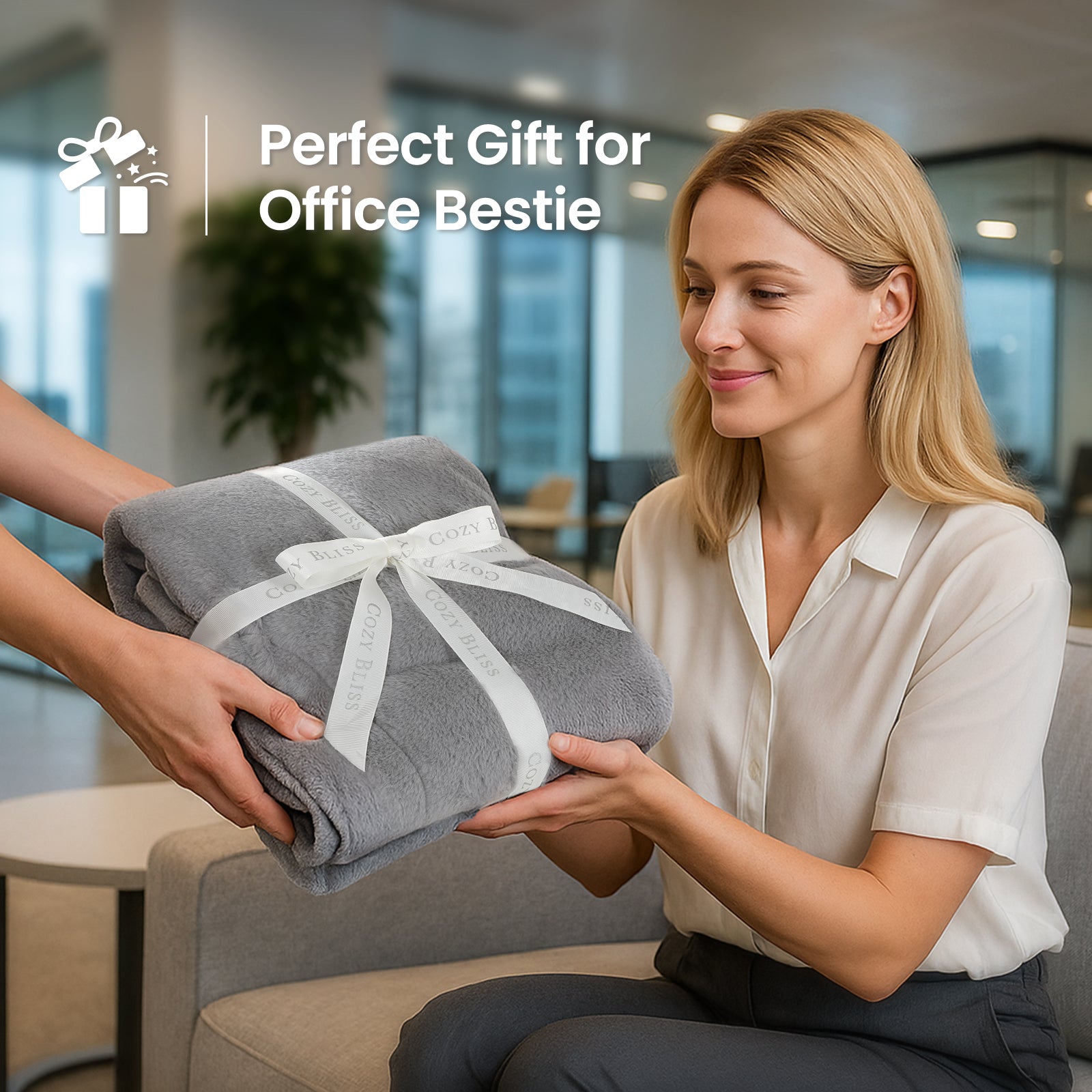 Woman receiving a folded gray blanket as a gift in an office setting #color_Grey