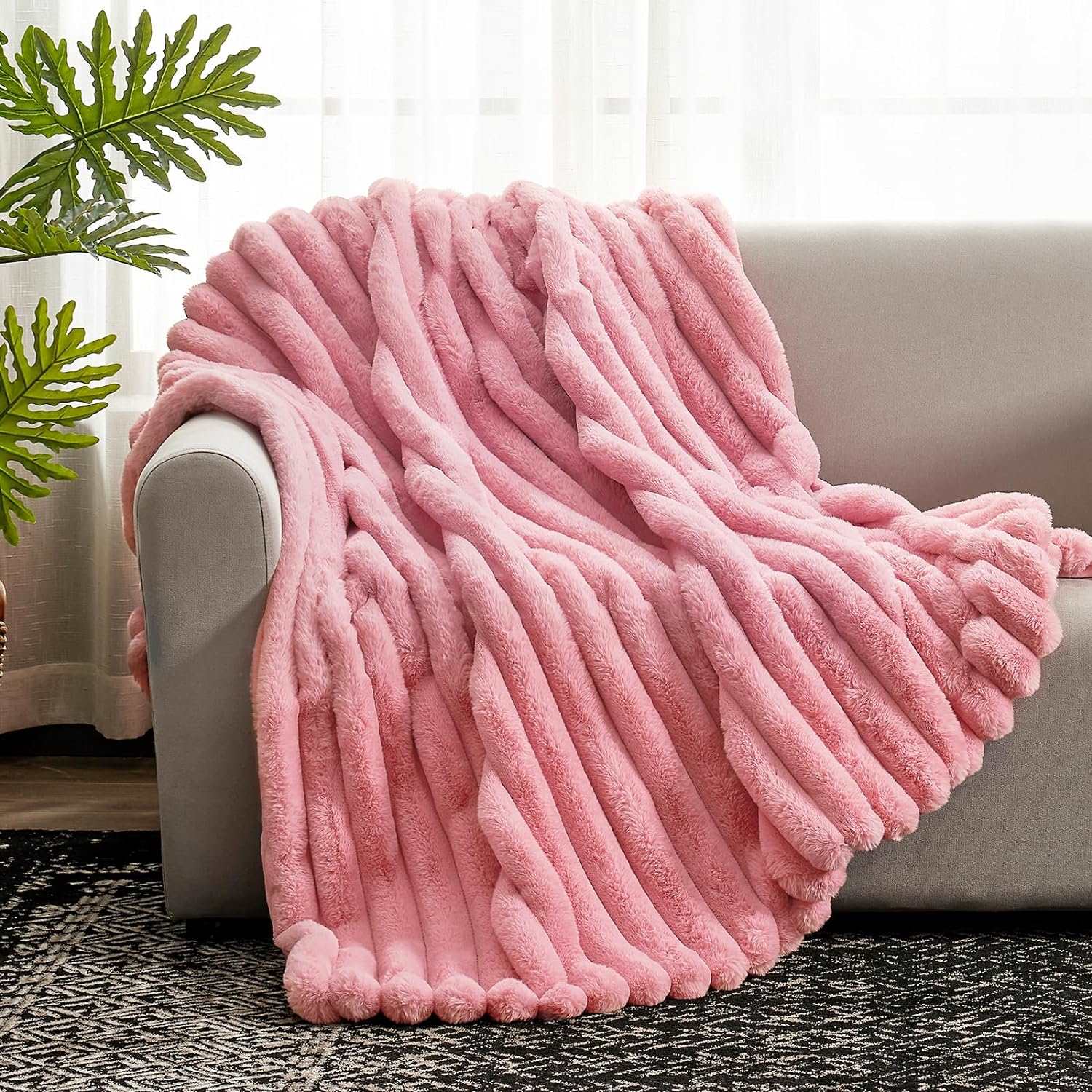 Pink striped faux fur blanket draped on a gray sofa. Soft and cozy, perfect for adding warmth to your home #color_Hot Pink