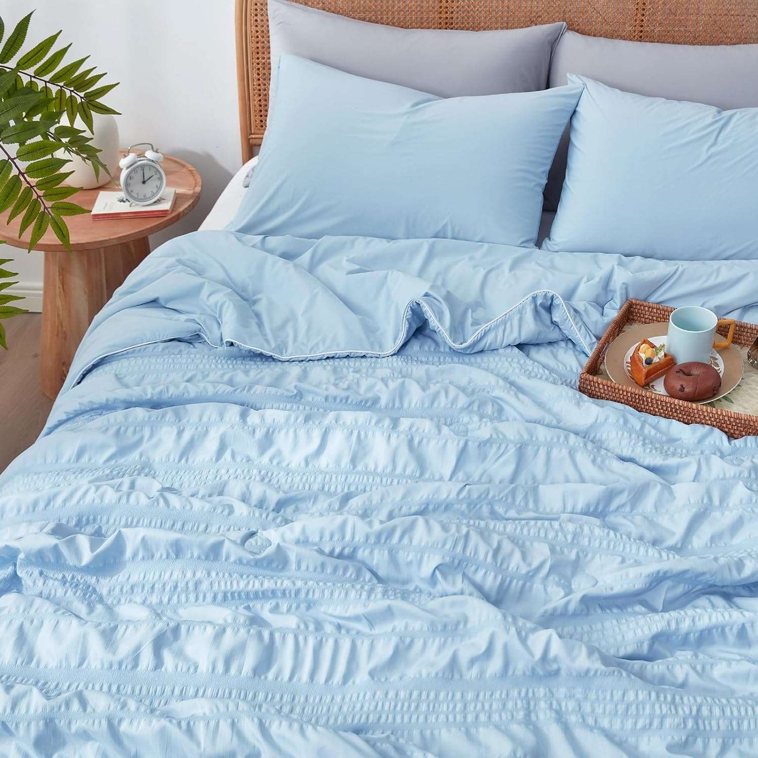 Cozy Bliss Seersucker Cooling Comforter on bed with breakfast tray #color_Blue