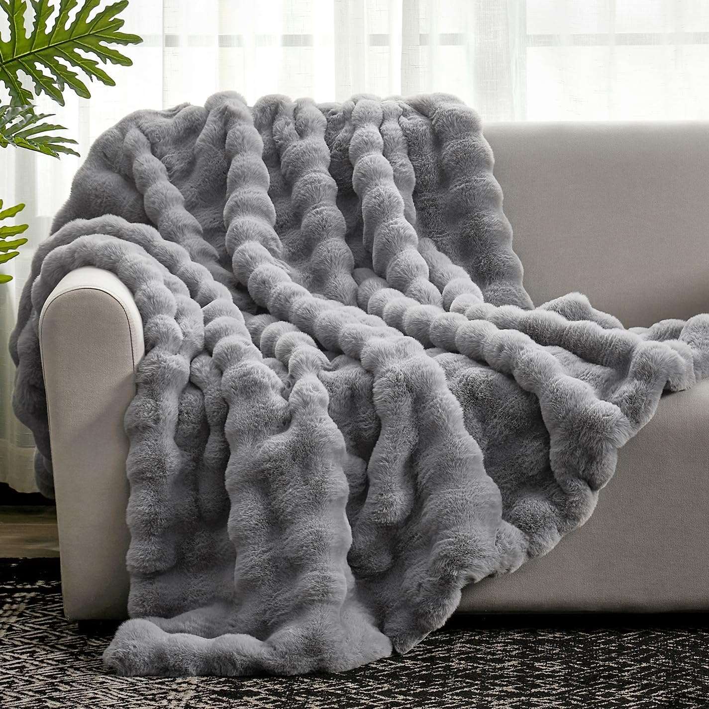 Gray Bubble Faux Fur Throw Blanket on a gray sofa #color_Grey