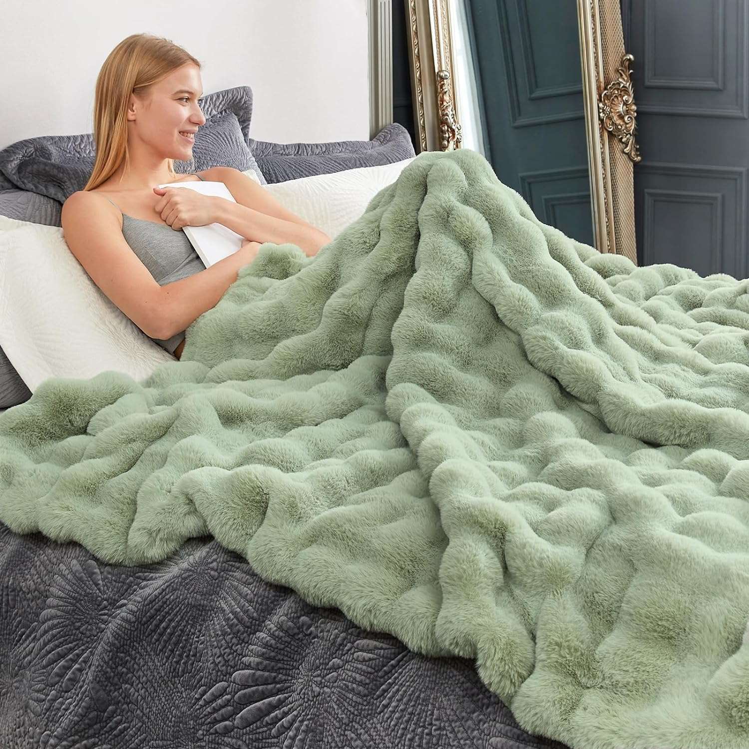 Woman relaxing with green bubble faux fur blanket #color_Sage Green
