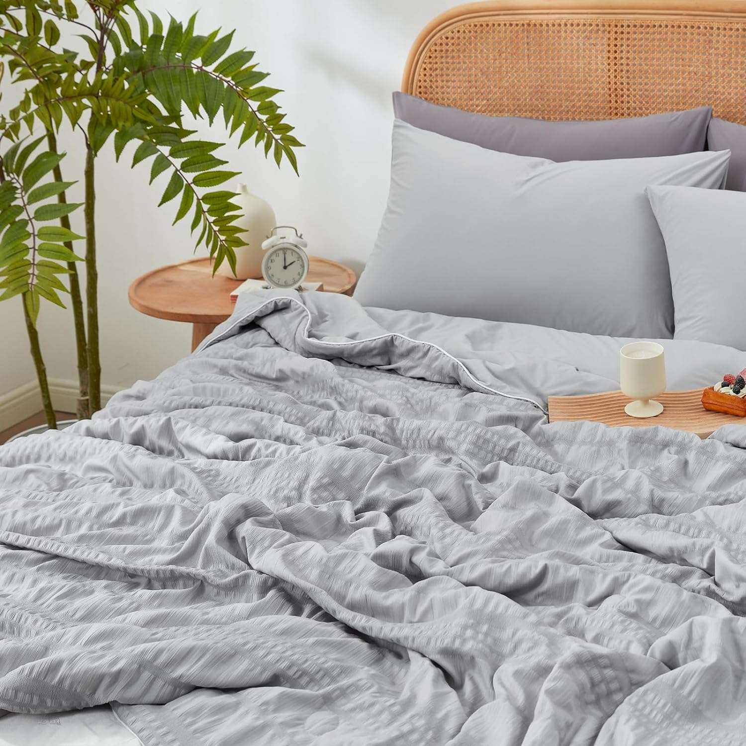 Gray seersucker cooling comforter on bed, breathable blanket for cozy sleep, perfect for hot sleepers #color_Light Grey