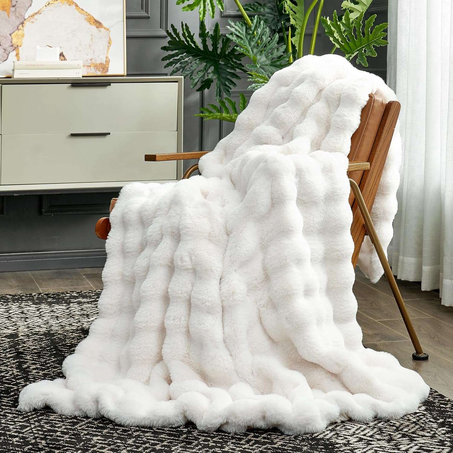 Cozy Bliss Bubble Faux Fur Throw Blanket draped over a chair #color_Cream White