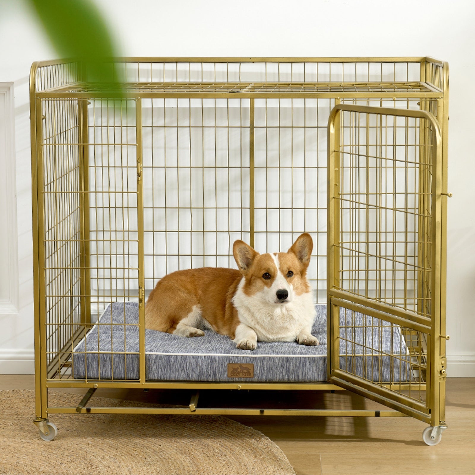 Dog lying on a cooling cushion inside a gold metal dog crate.#color_Grey