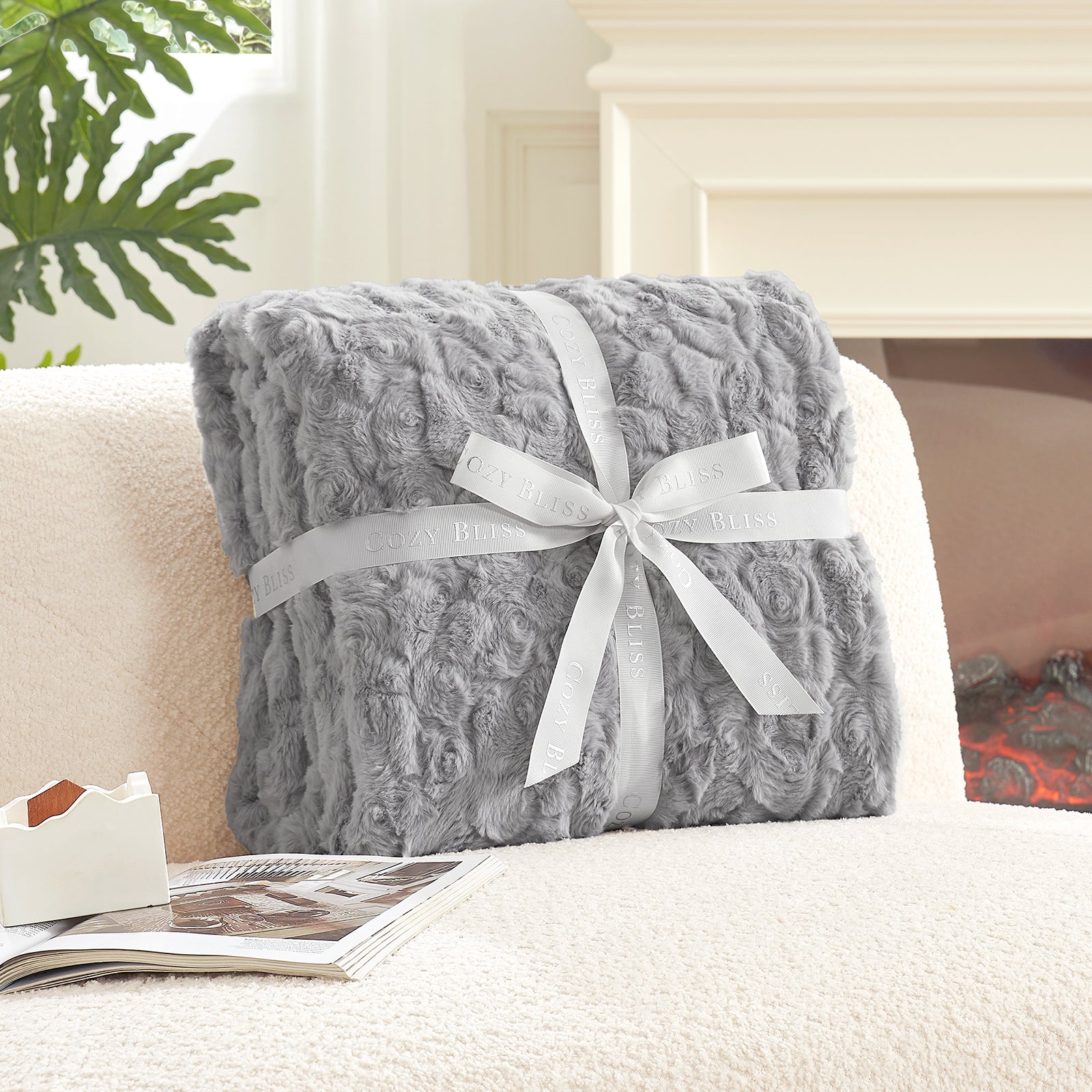 Gray textured blanket with a white ribbon on a white surface #color_Grey