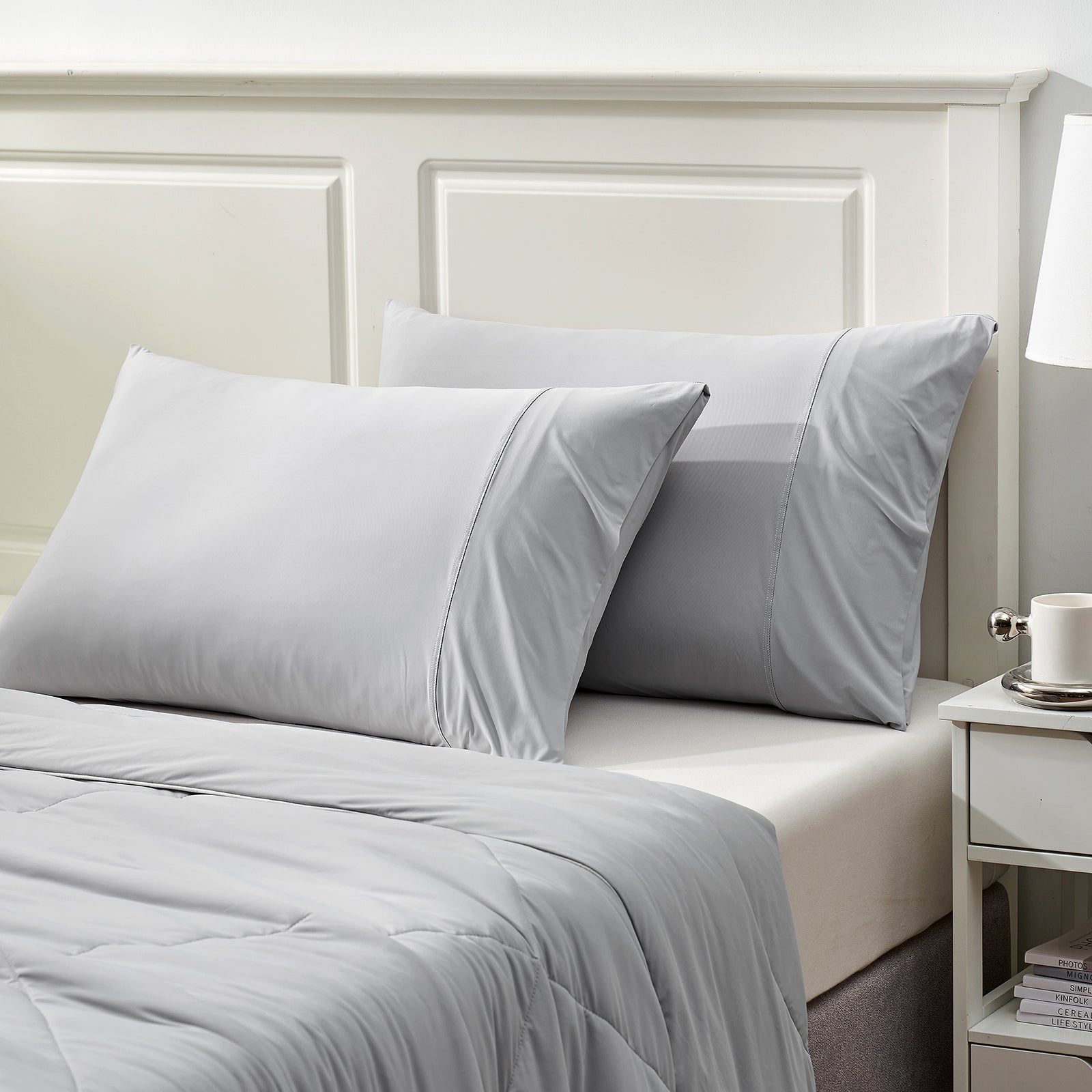 Gray cooling pillowcases on bed, breathable Arc-Chill fabric, soft cozy bedding set for cool sleep #color_Light Grey
